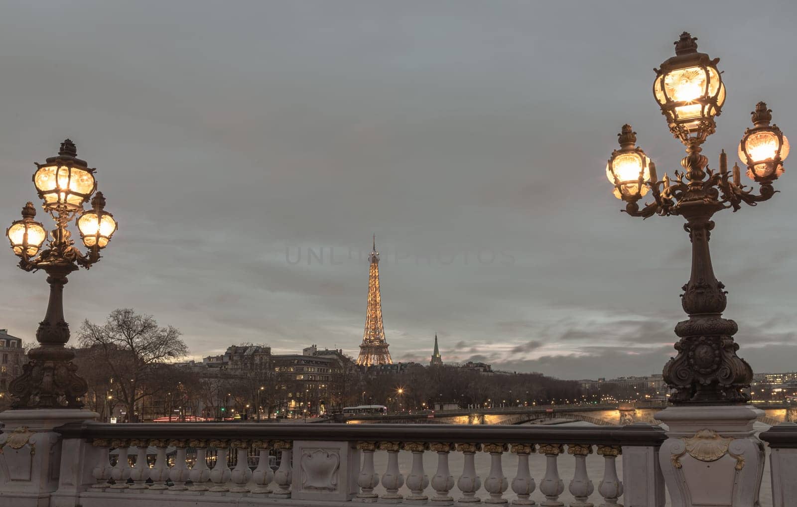 France, Paris - Jan 4, 2024 - Nice scenery of Eiffel Tower and Seine River in Paris. View from Pont Alexandre III Bridge at sunset. Destinations in Europe. Space for text, Selective focus.