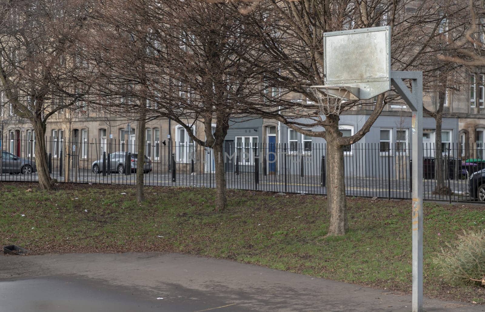 Edinburgh, Scotland, Jan 19, 2024 - Basketball backboard with the hoop metal ring in outdoor basketball courts at the city downtown. Space for text, Selective focus.