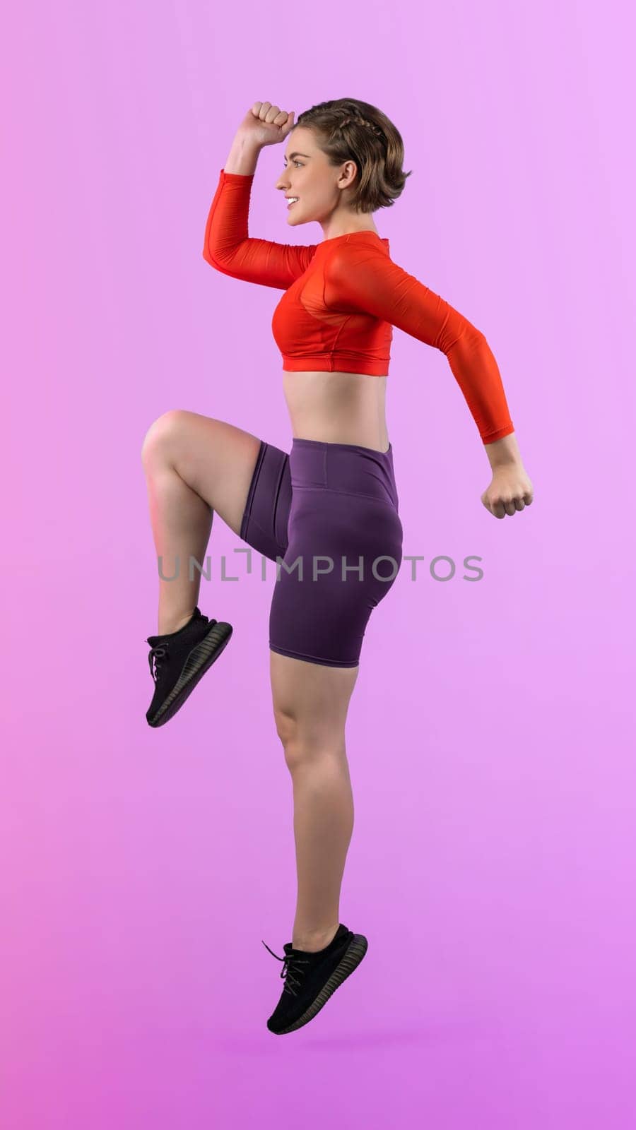 Full body length gaiety shot athletic and sporty young woman fitness running cardio exercise posture on isolated background. Healthy active and body care lifestyle.