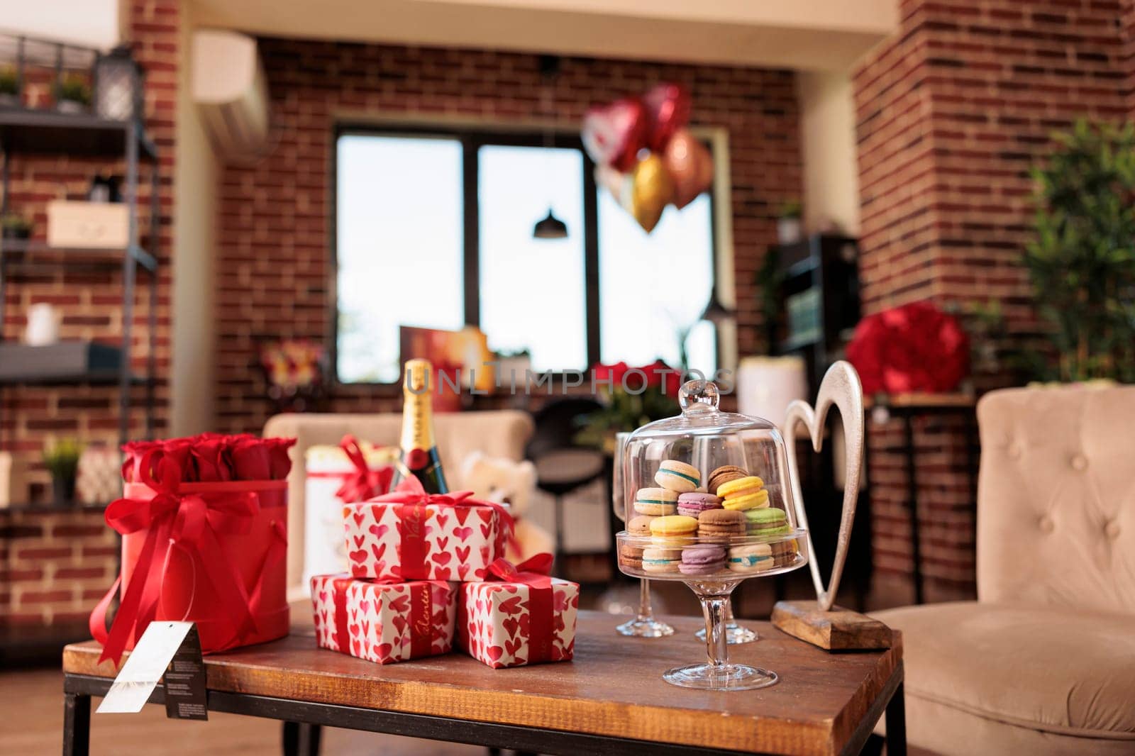 Empty apartment filled with romantic presents and red roses, waiting for boyfriend and girlfriend to come and enjoy valentine s day. Living room full with ballons and wine. Love holiday concept