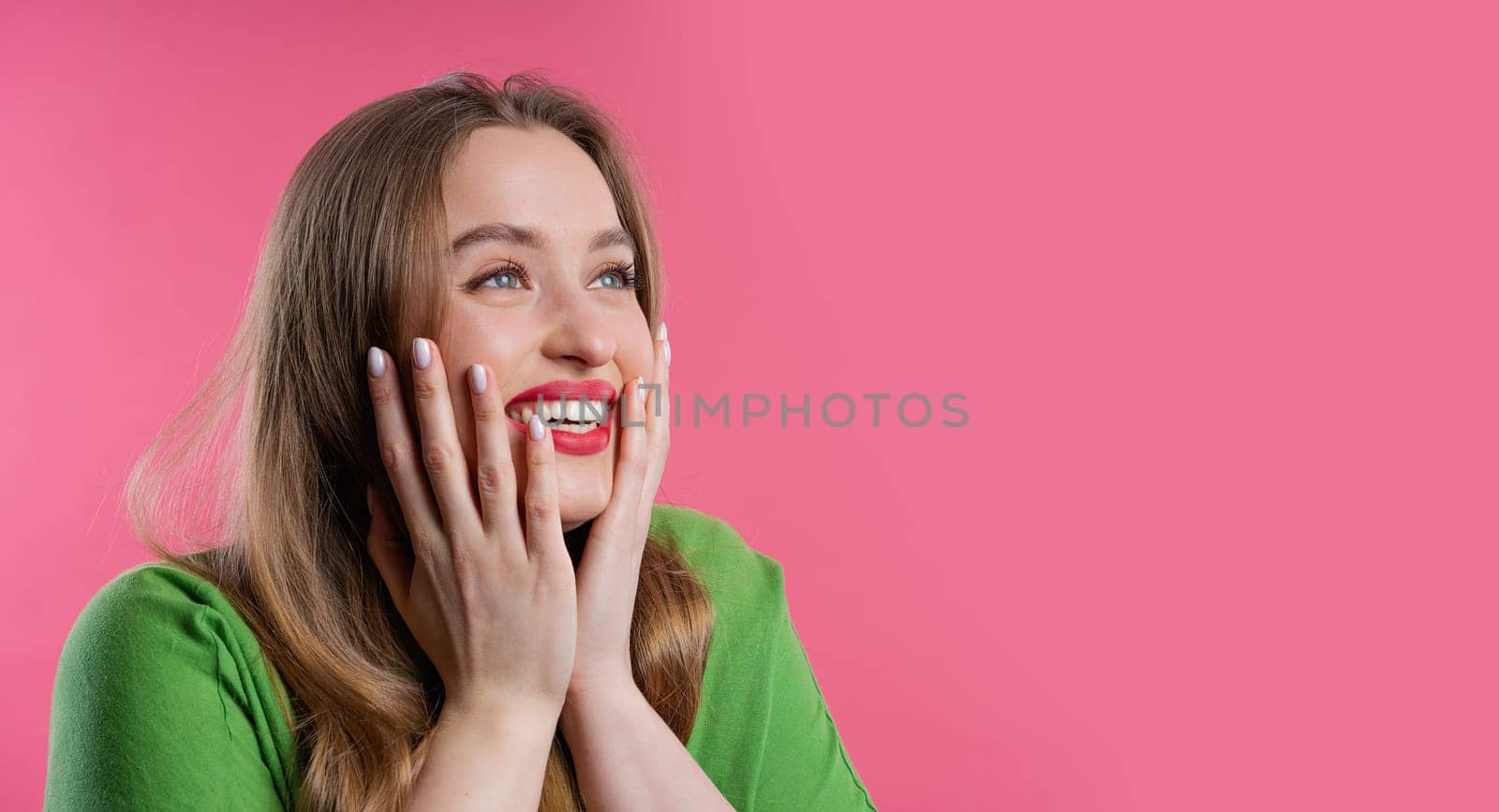 Amazed woman, she expresses WOW. Impressed teenager trying to get attention. Concept of sales, profitable offer. Excited romantic girl on pink background. High quality