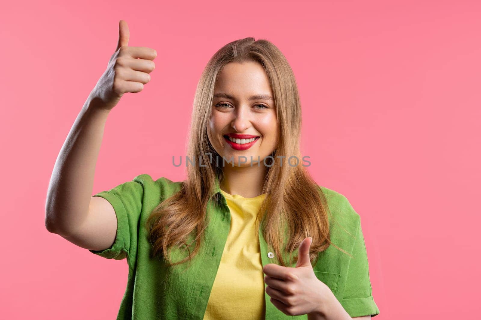 Stylish woman with hand sign like, thumbs up gesture. Lady on pink background by kristina_kokhanova