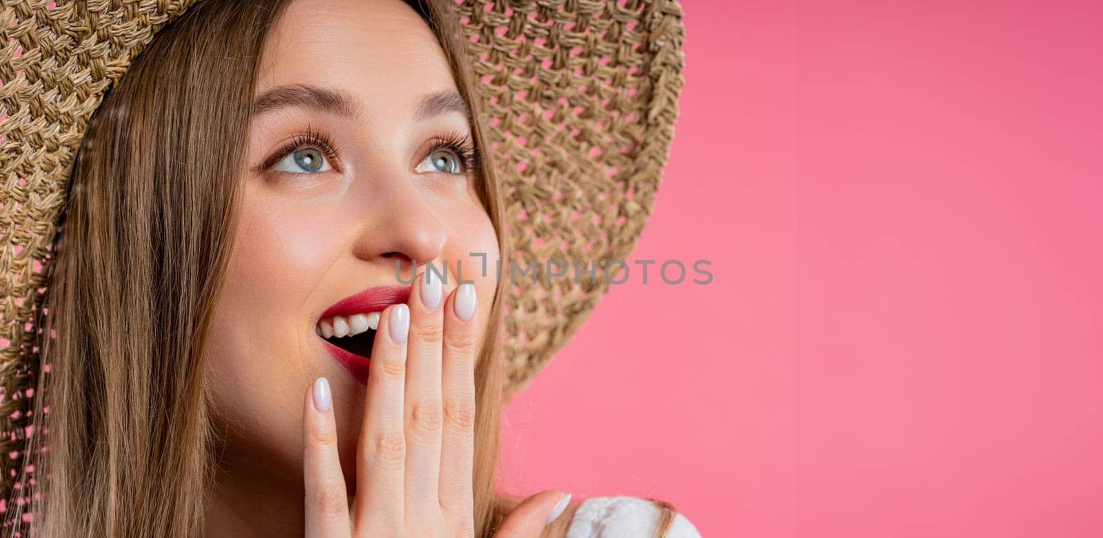 Amazed woman, she expresses WOW. Impressed teenager trying to get attention. Concept of sales, profitable offer. Excited romantic girl on pink background. High quality