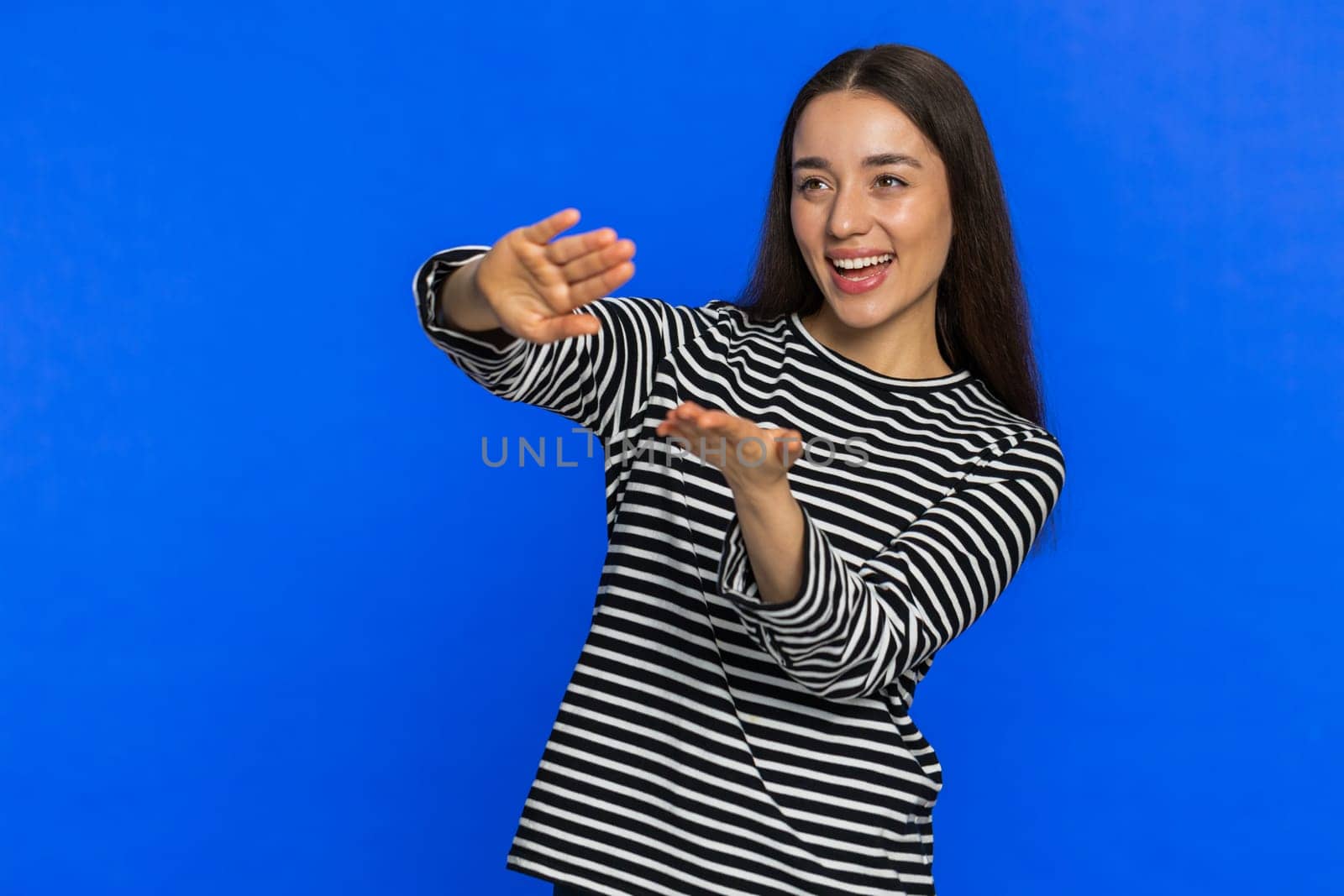 Caucasian woman showing wasting throwing sharing money around, more tips, big profit, winning lottery jackpot, successful shopping payment purchase cashback. Pretty girl isolated on blue background