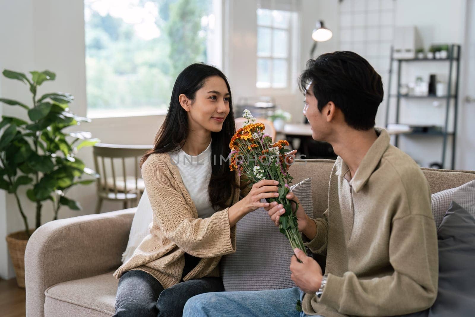 Young couple Hug and giving flower on Valentine's Day. Romantic day together. Valentine's Day concept.