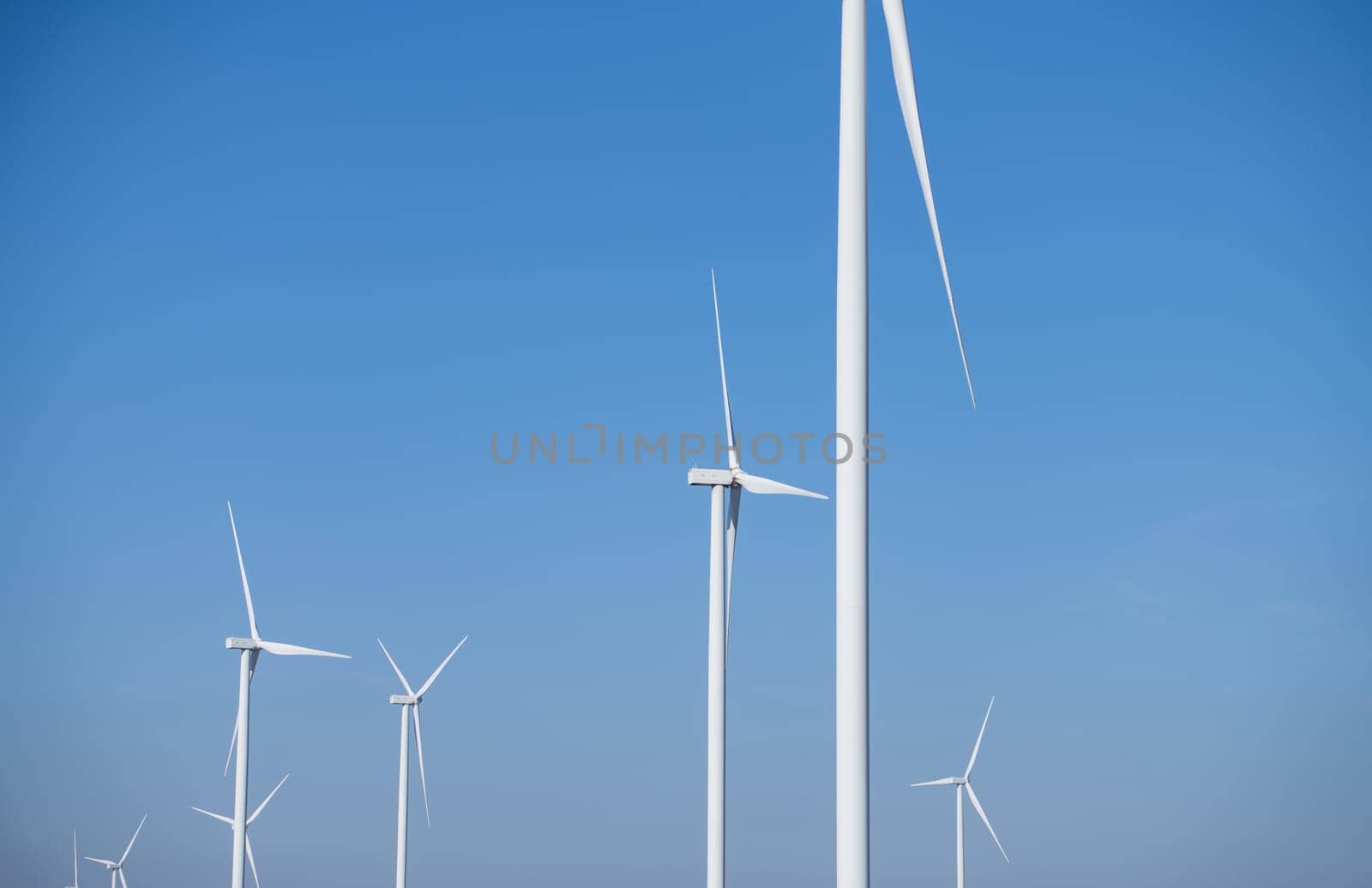 Wind energy. Wind power. Sustainable, renewable energy. Wind turbines generate electricity. Wind farm. Sustainable resources. Sustainable development. Green technology for energy sustainability.