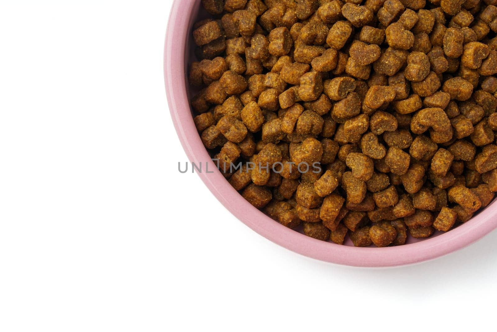 Bowl with dry pet food isolated on white background close up