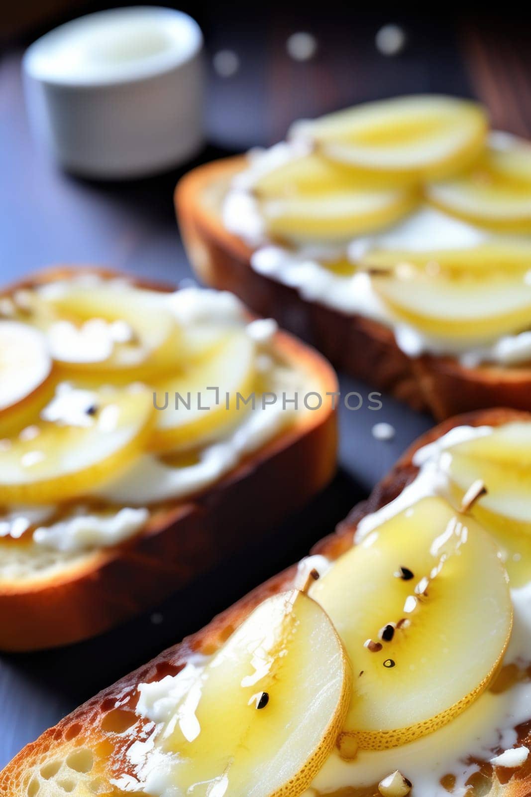 Bruschetta with caramelized pears and cheese, delicious crostini for gourmet breakfast, brunch or lunch, close up, vertical image
