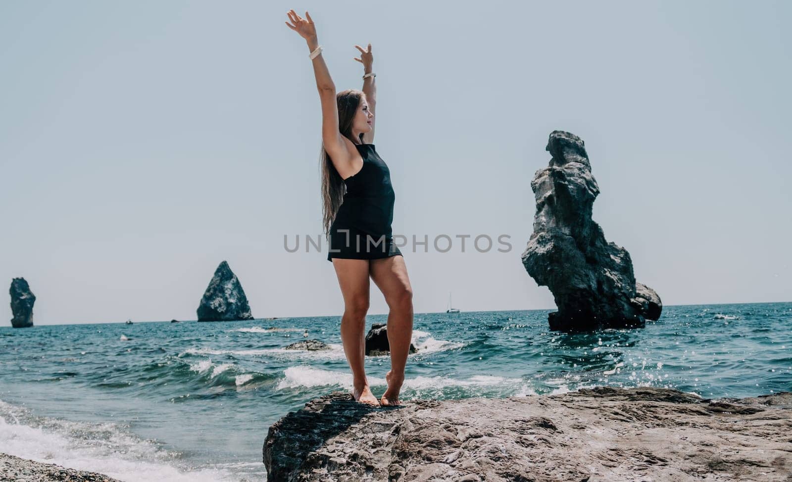 Woman summer travel sea. Happy tourist in hat enjoy taking picture outdoors for memories. Woman traveler posing on the beach at sea surrounded by volcanic mountains, sharing travel adventure journey by panophotograph