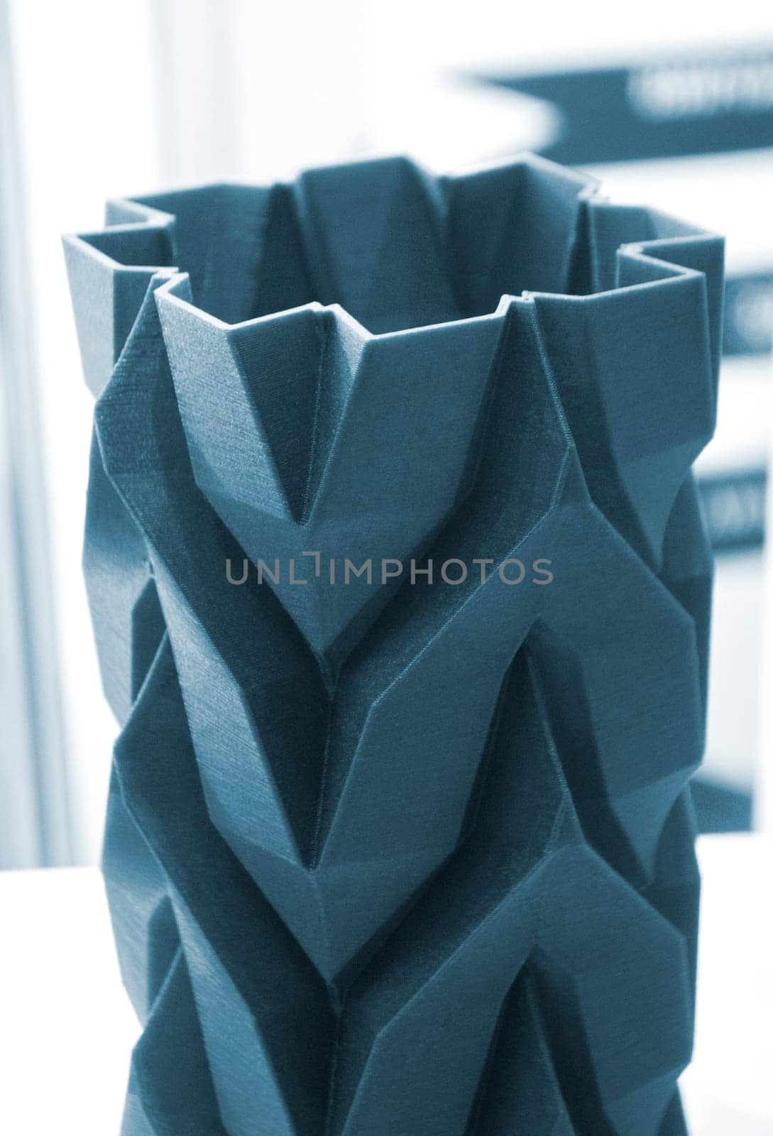 Art object vase printed on a 3D printer. Models created by a 3D printer from blue molten plastic. Concept 3d printing. Additive progressive technologies. New modern technology for creating objects