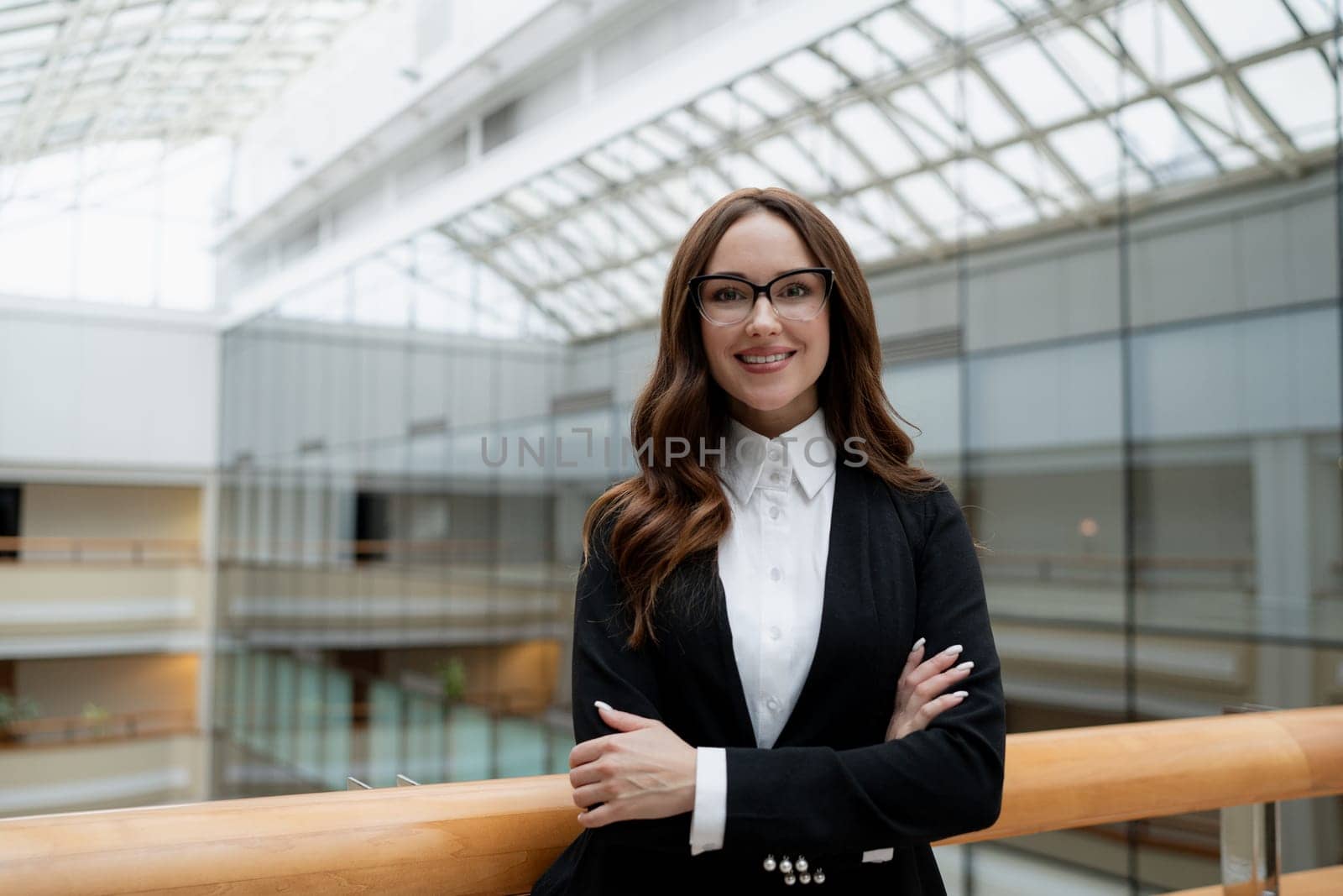 Mature business woman looking at the camera in a workplace meeting area.