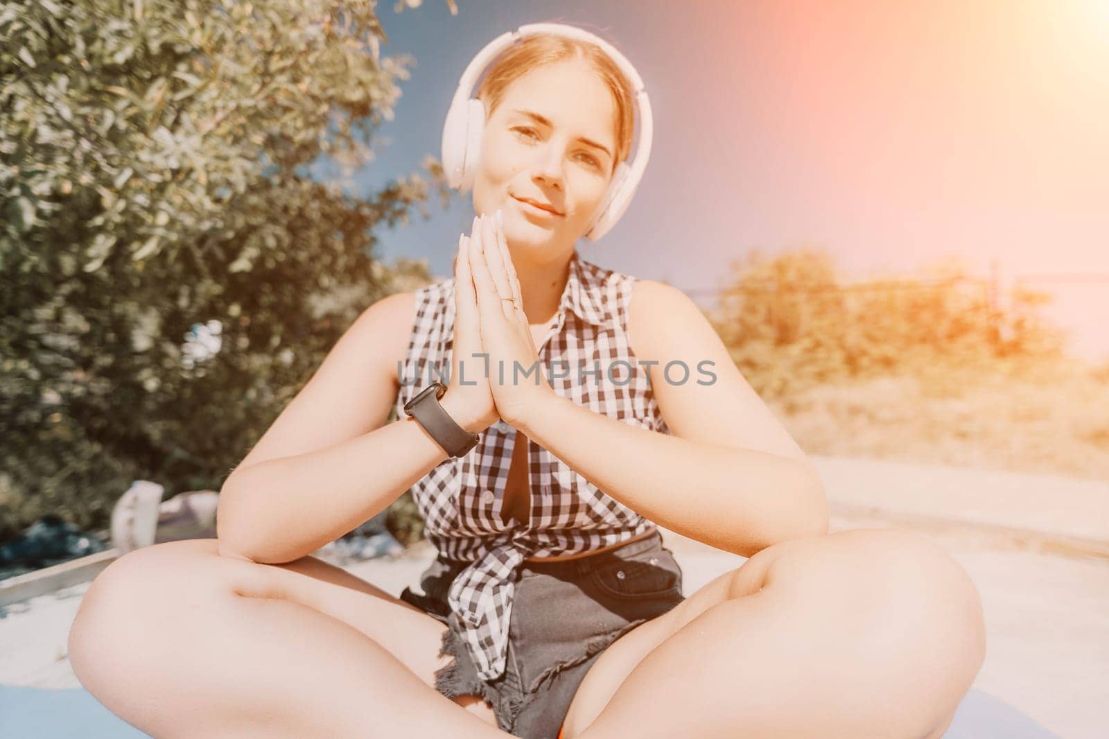 Woman laptop sea. Working remotely on seashore. Happy successful woman female freelancer working on laptop by the sea at sunset, makes a business transaction online. Freelance, remote work on vacation by panophotograph