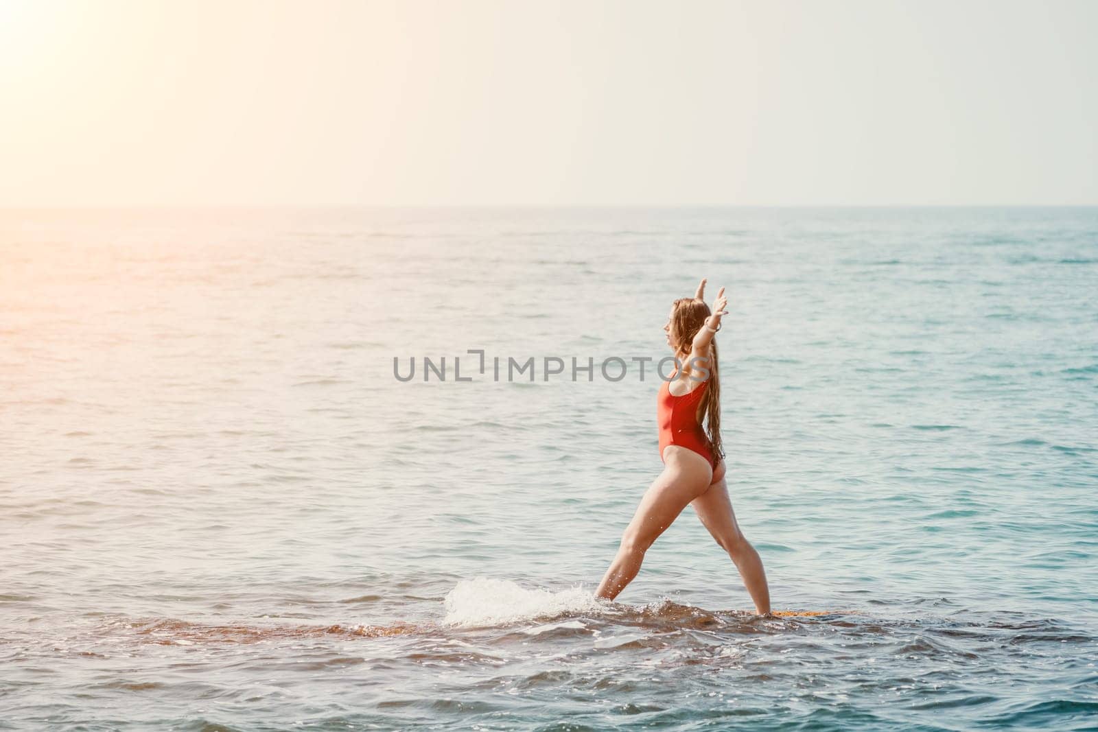 Woman sea yoga. Back view of free calm happy satisfied woman with long hair standing on top rock with yoga position against of sky by the sea. Healthy lifestyle outdoors in nature, fitness concept.