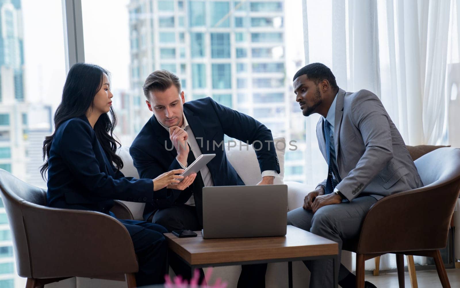 Young smart businesswoman showing data analysis to diverse investor by using tablet. Multicultural business group discussing and investing in start up project. Modern office. Meeting. Ornamented.