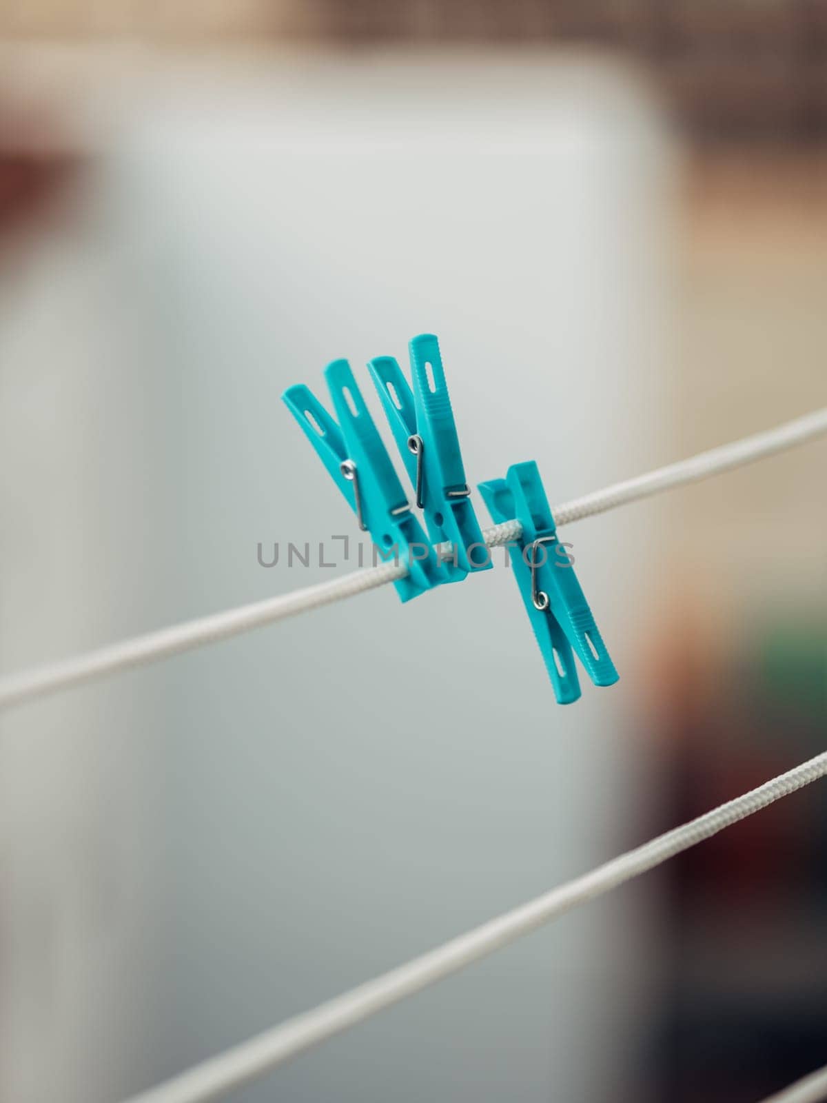 Teal Clothespins on a White Line by apavlin