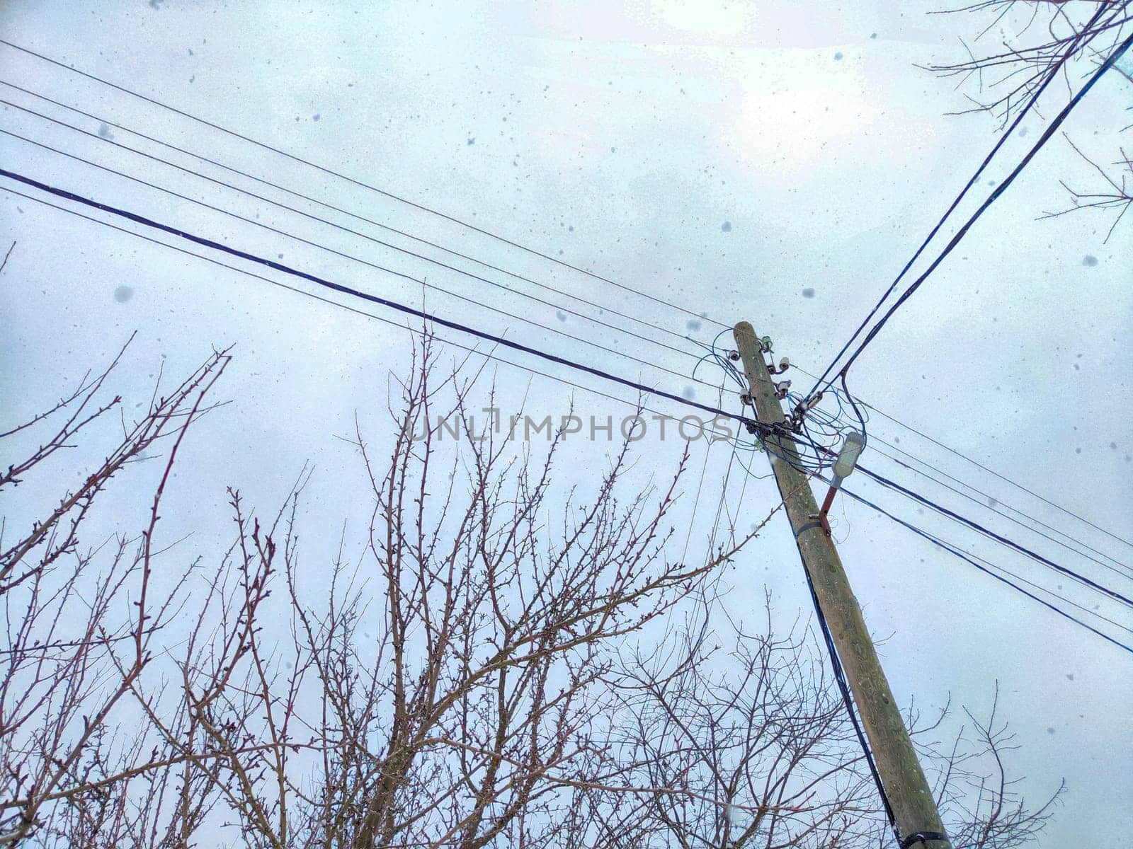Old pole with wires against the sky. Electric transmission line, Eco-friendly energy
