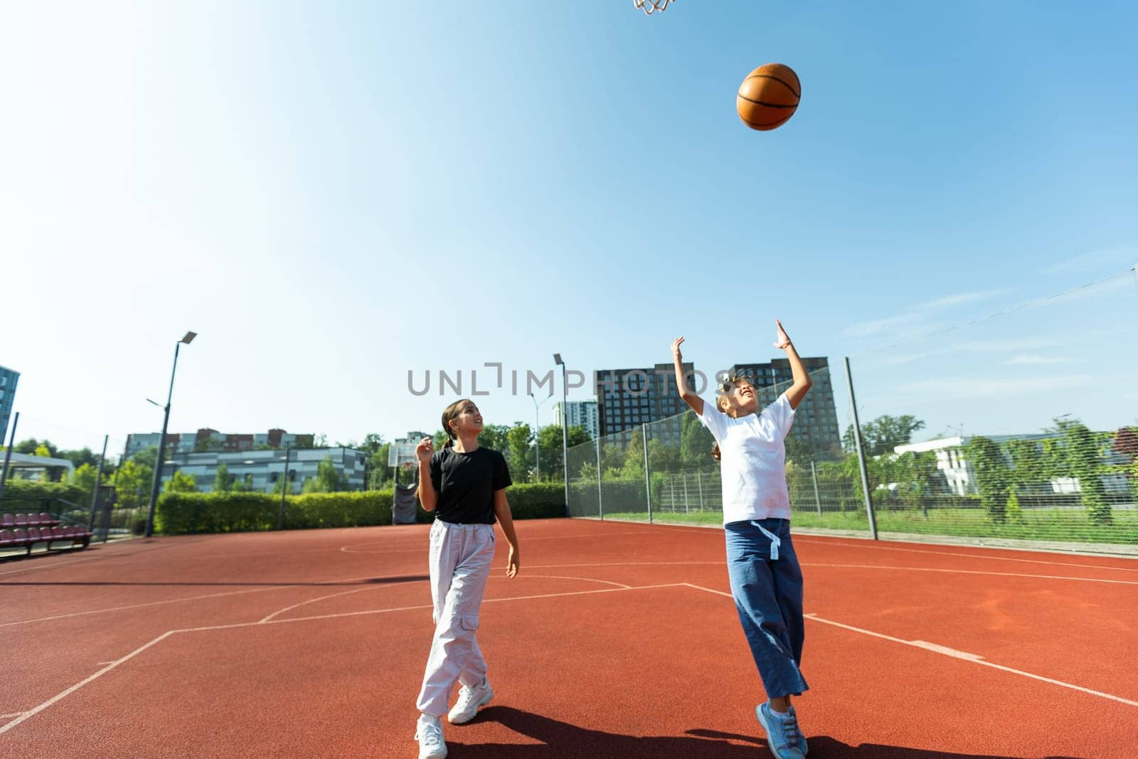Concept of sports, hobbies and healthy lifestyle. Young people playing basketball on playground outdoors by Andelov13
