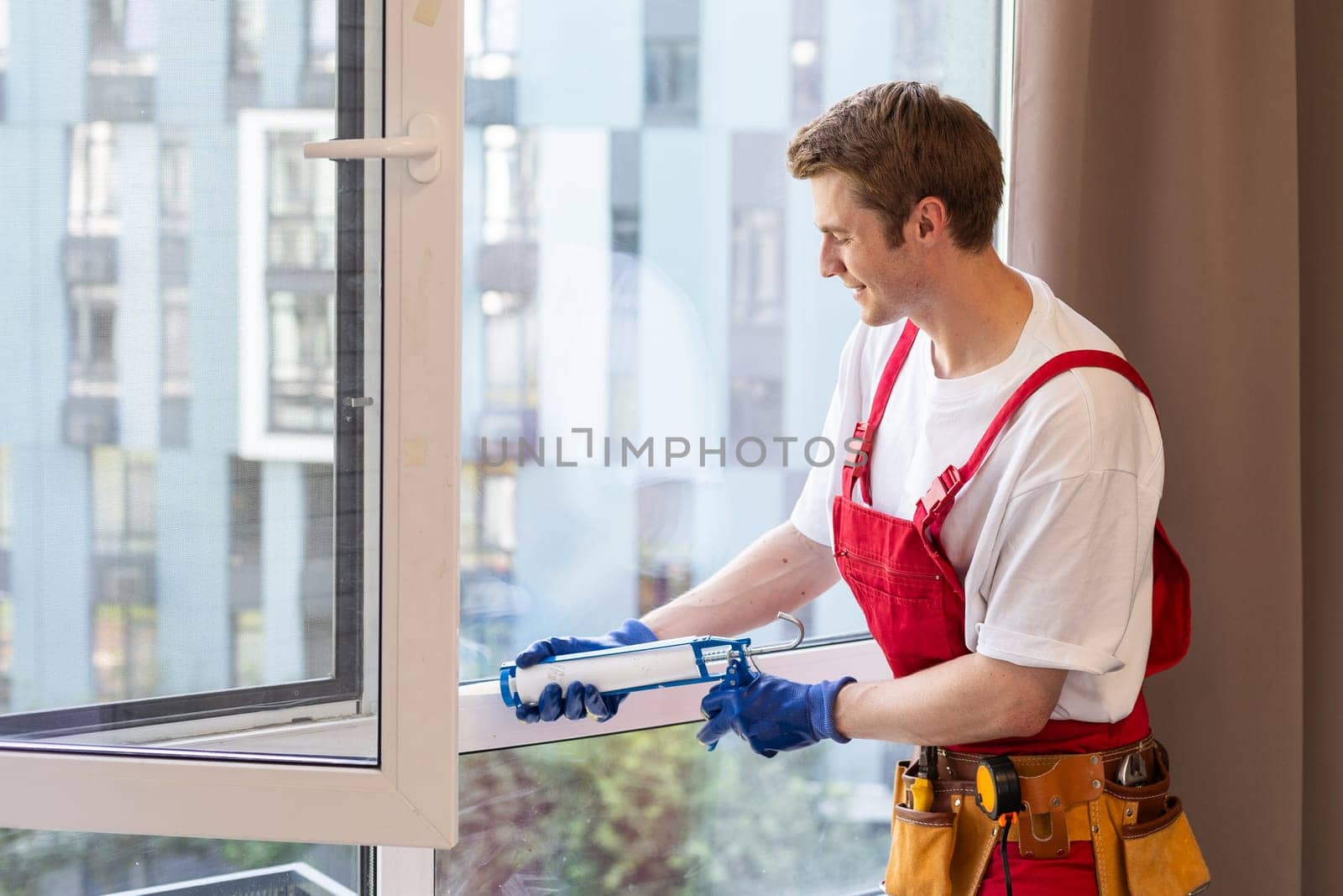 Worker installing plastic window indoors, closeup view by Andelov13