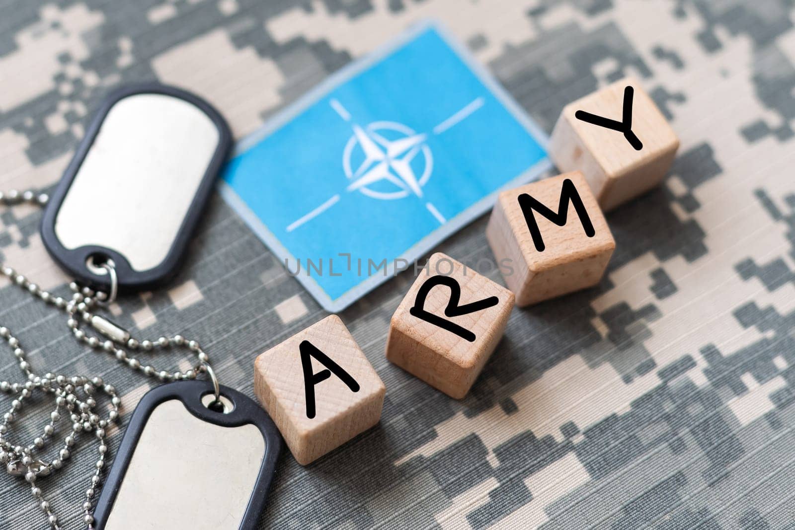 Military ID tags and US army patches on camouflage background. High quality photo