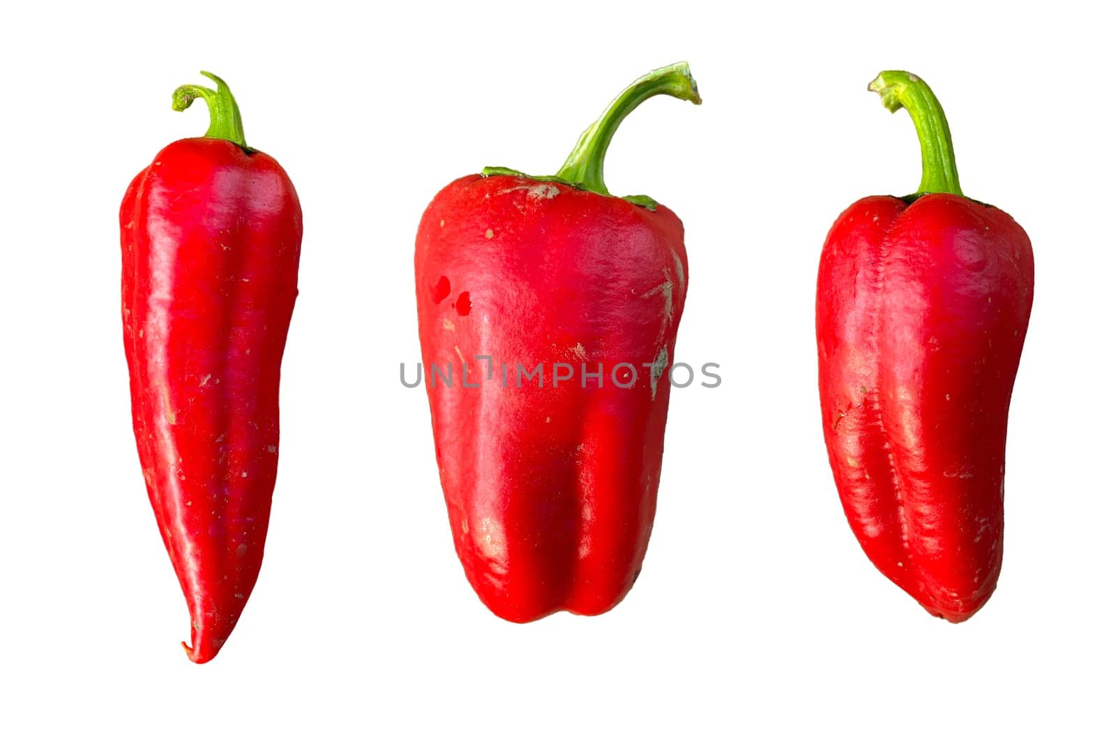 unwashed red peppers on a white background.