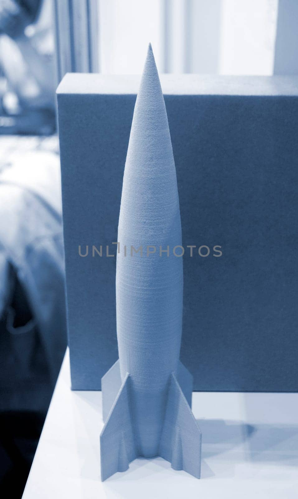 Art object model rocket printed on 3D printer. Rocket toy created by 3D printing from molten plastic. Example creating prototype by 3D printer. Concept 3D printing. Printing innovation technology