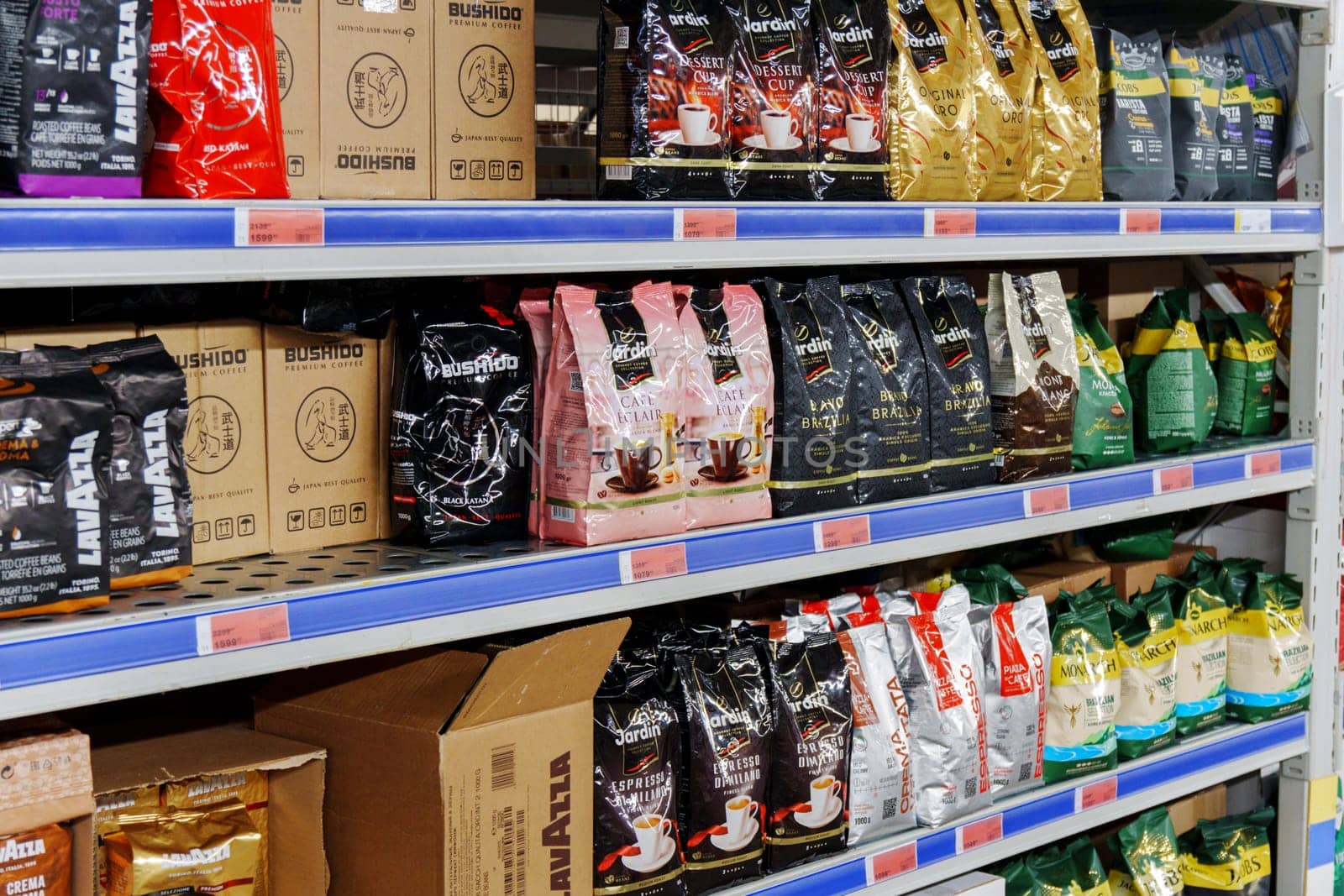 Tyumen, Russia-November 04, 2023: Grocery store shelves with coffee ground and whole beans in bags in various flavors.
