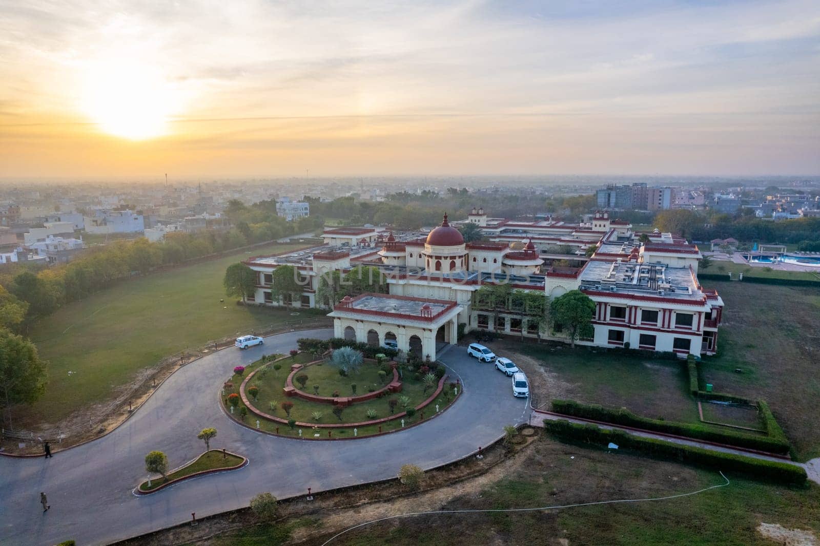 Aerial drone shot of royal palace hotel resort at sunrise showing the elegant buildings in the city of Jodhpur, Udaipur in Rajasthan by Shalinimathur