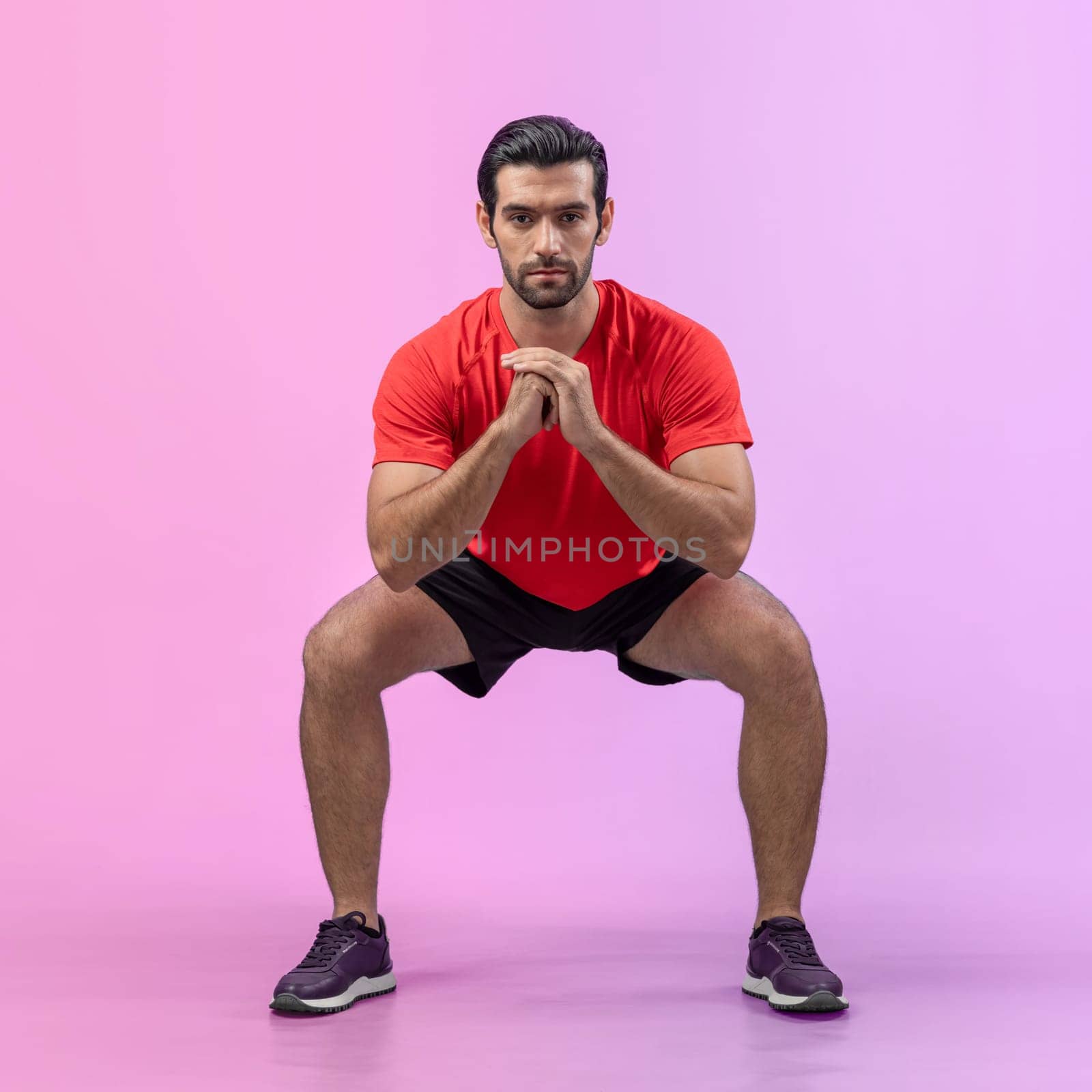 Full body length gaiety shot athletic and sporty young man with fitness in squat exercise posture on isolated background. Healthy active and body care lifestyle.