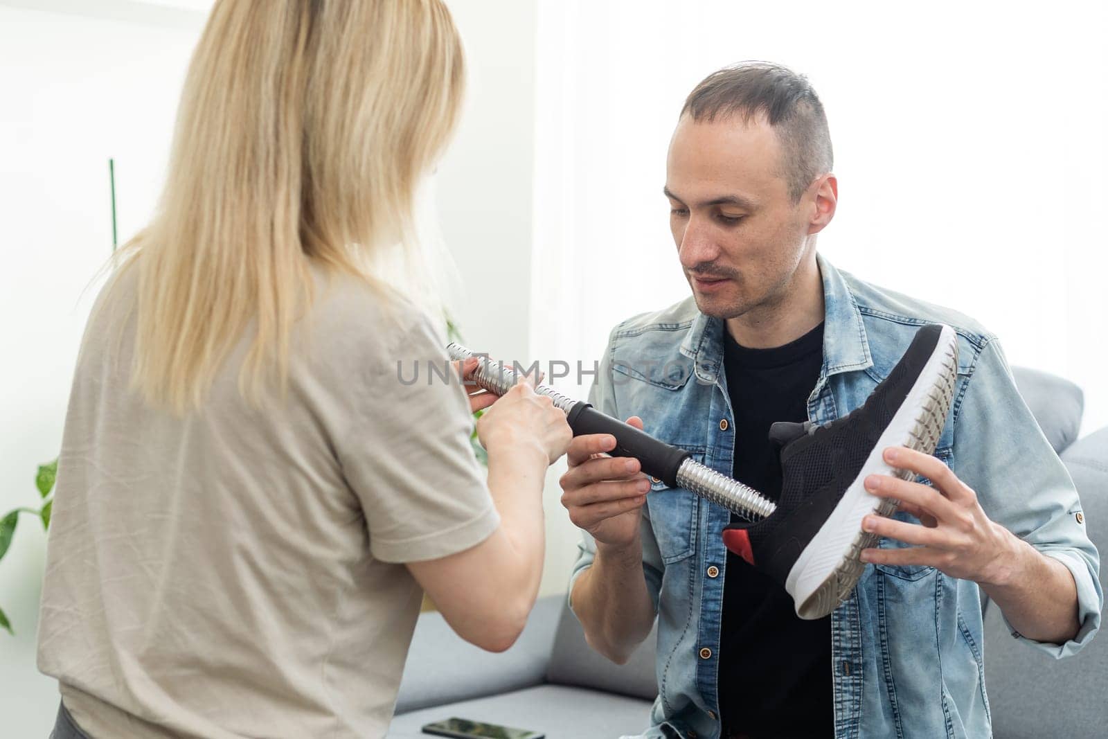 Female physiotherapist adjusting prosthetic leg of patient in hospital. High quality photo