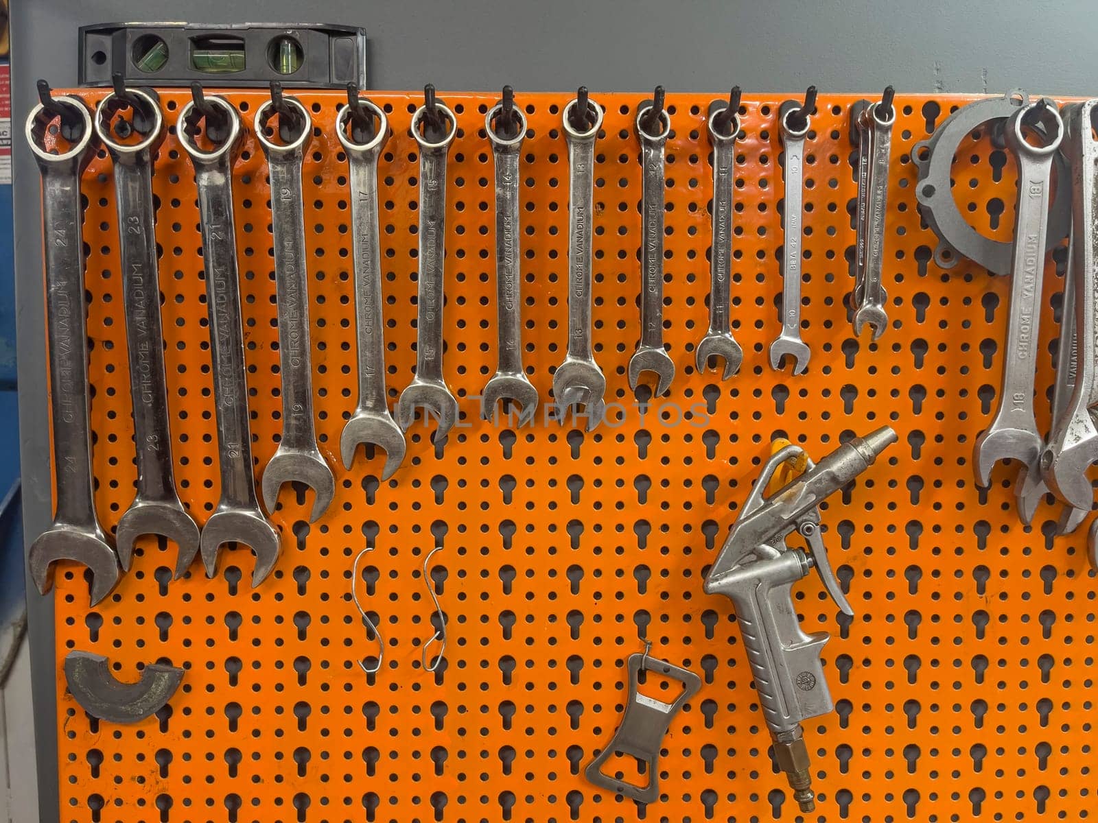 A photo showcasing a variety of wrenches neatly arranged and hanging on a wall.