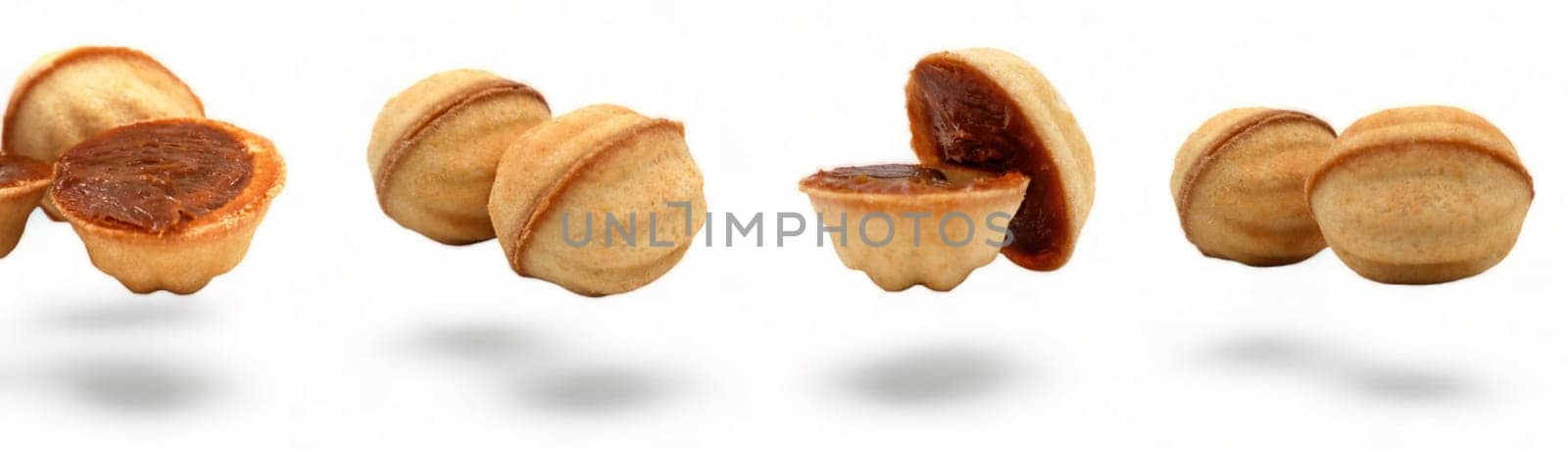 Banner with fresh and delicious cookies in the shape of a walnut with boiled condensed milk on a white background. A favorite delicacy for children and adults with a delicate filling inside