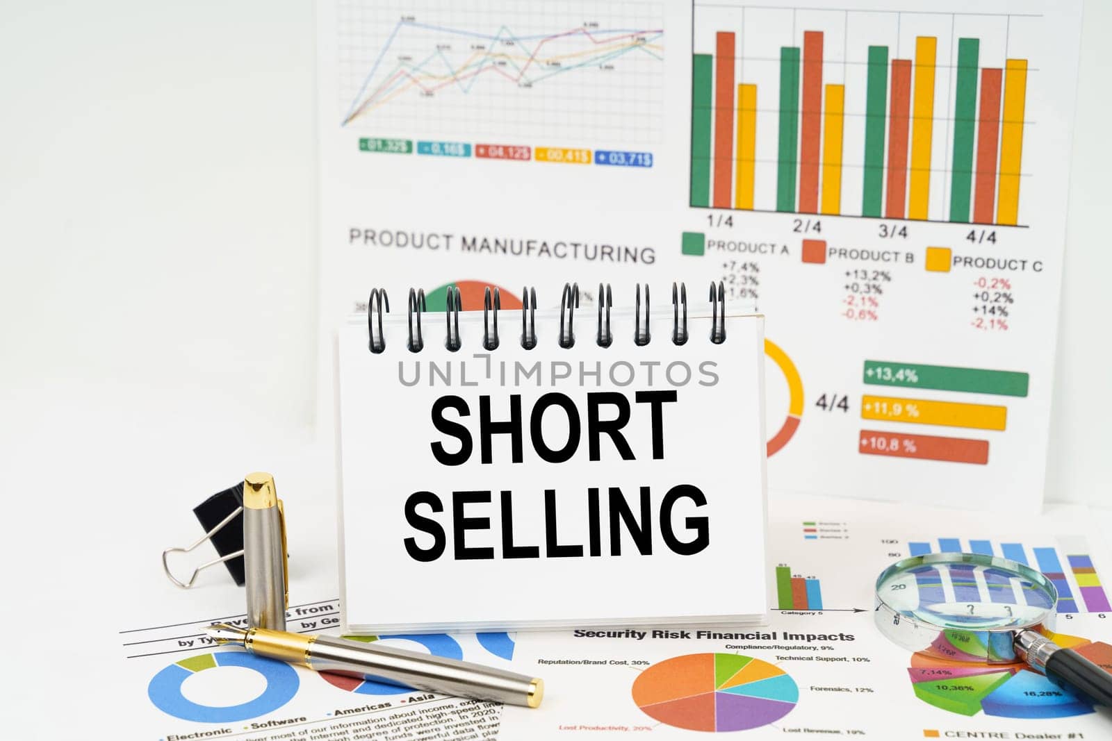 Business concept. On the table are reports with graphs and a notepad with the inscription - Short selling