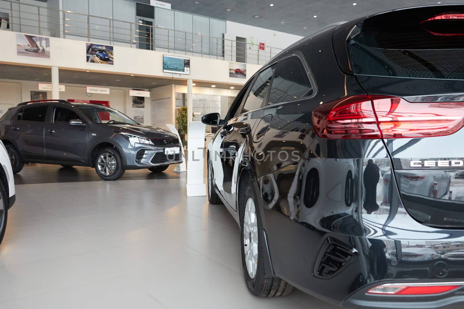 Kazan, Russia - November 25, 2022: Cars in showroom of dealership Kia in Kazan in Russia. Partial focus