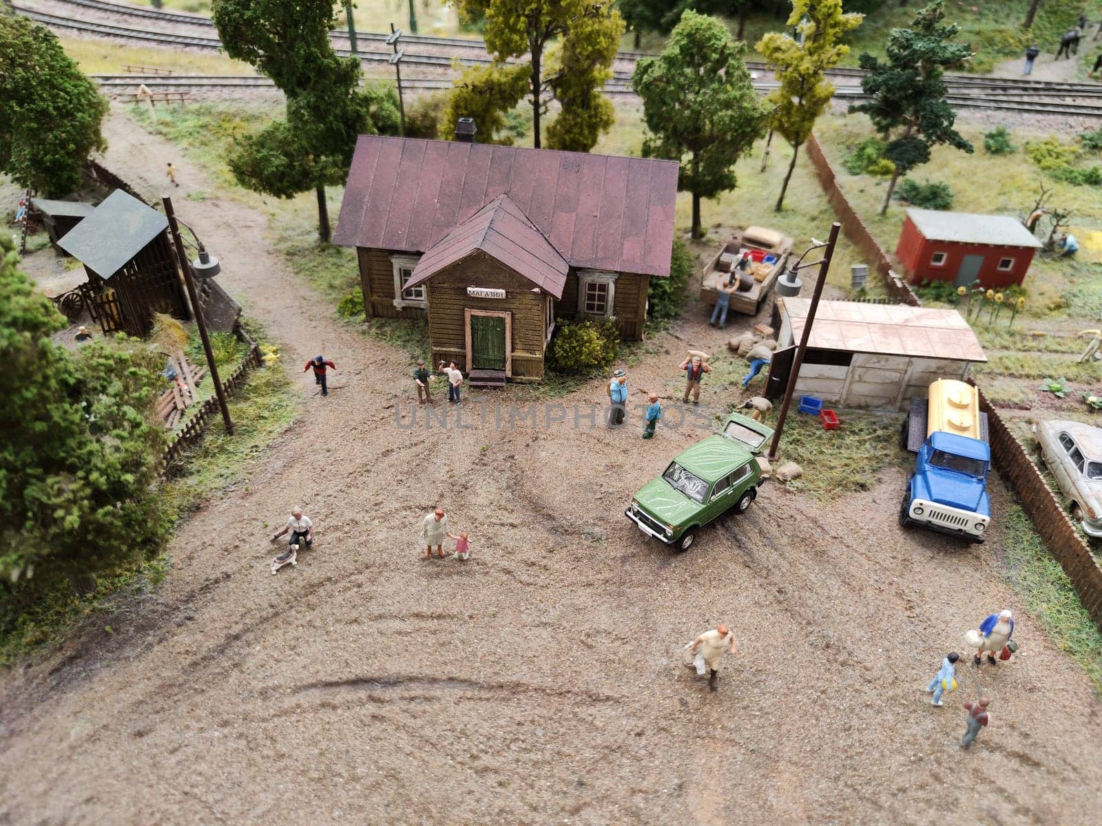 Saint-Petersburg, Russia - August 03, 2023: Grand project Russia. Layout of a city, country, street, landscape with small toy people, houses, roads, cars and nature