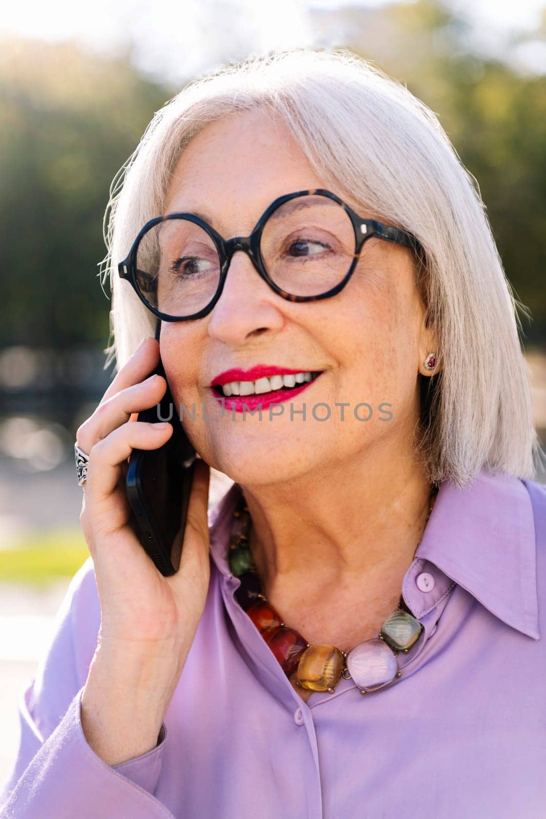 senior woman talking happy by mobile phone by raulmelldo