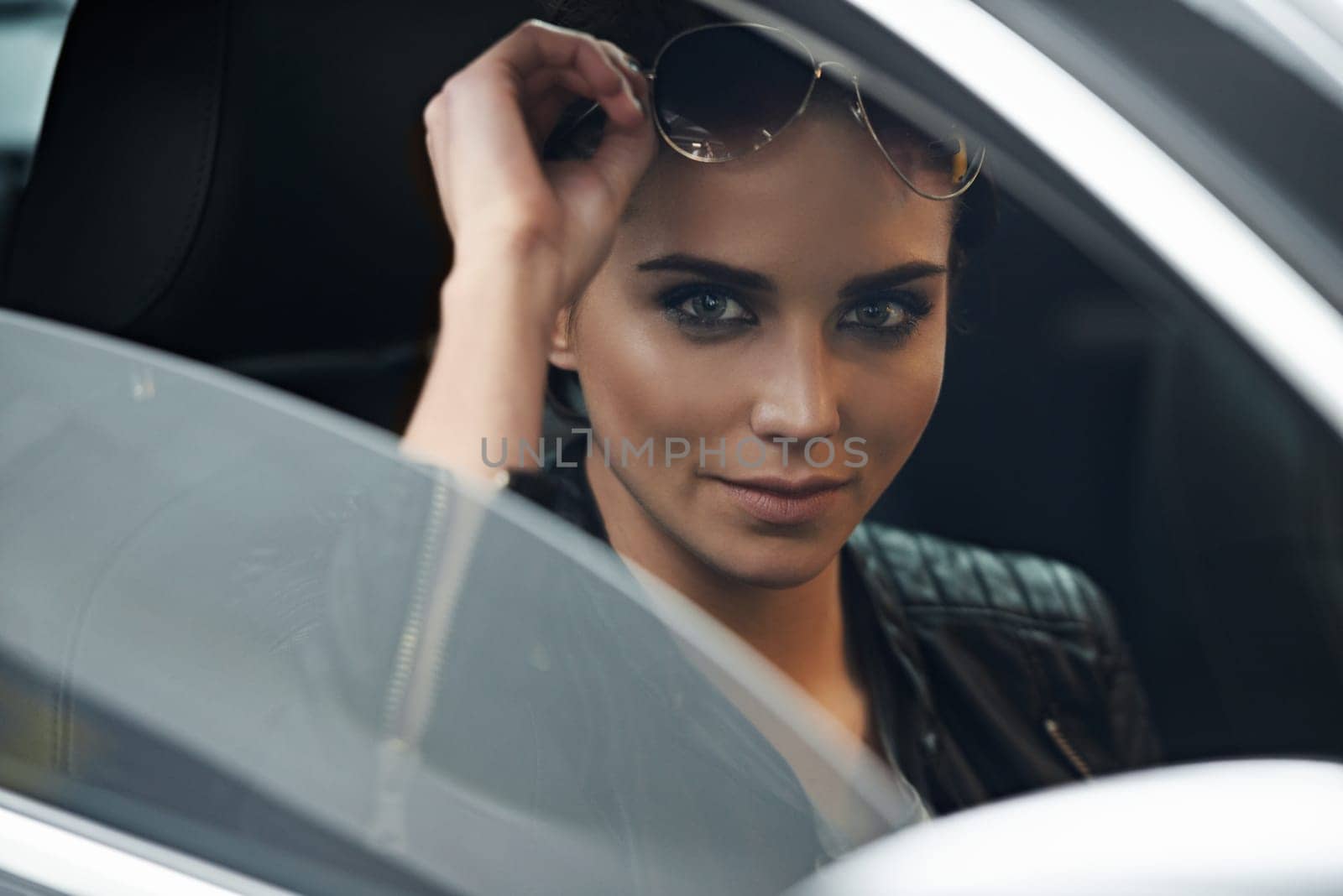 Woman, car and portrait while driving for a roadtrip commute in a luxury vehicle. Female person, face and window of a transportation motor for trip with confidence to travel destination by YuriArcurs