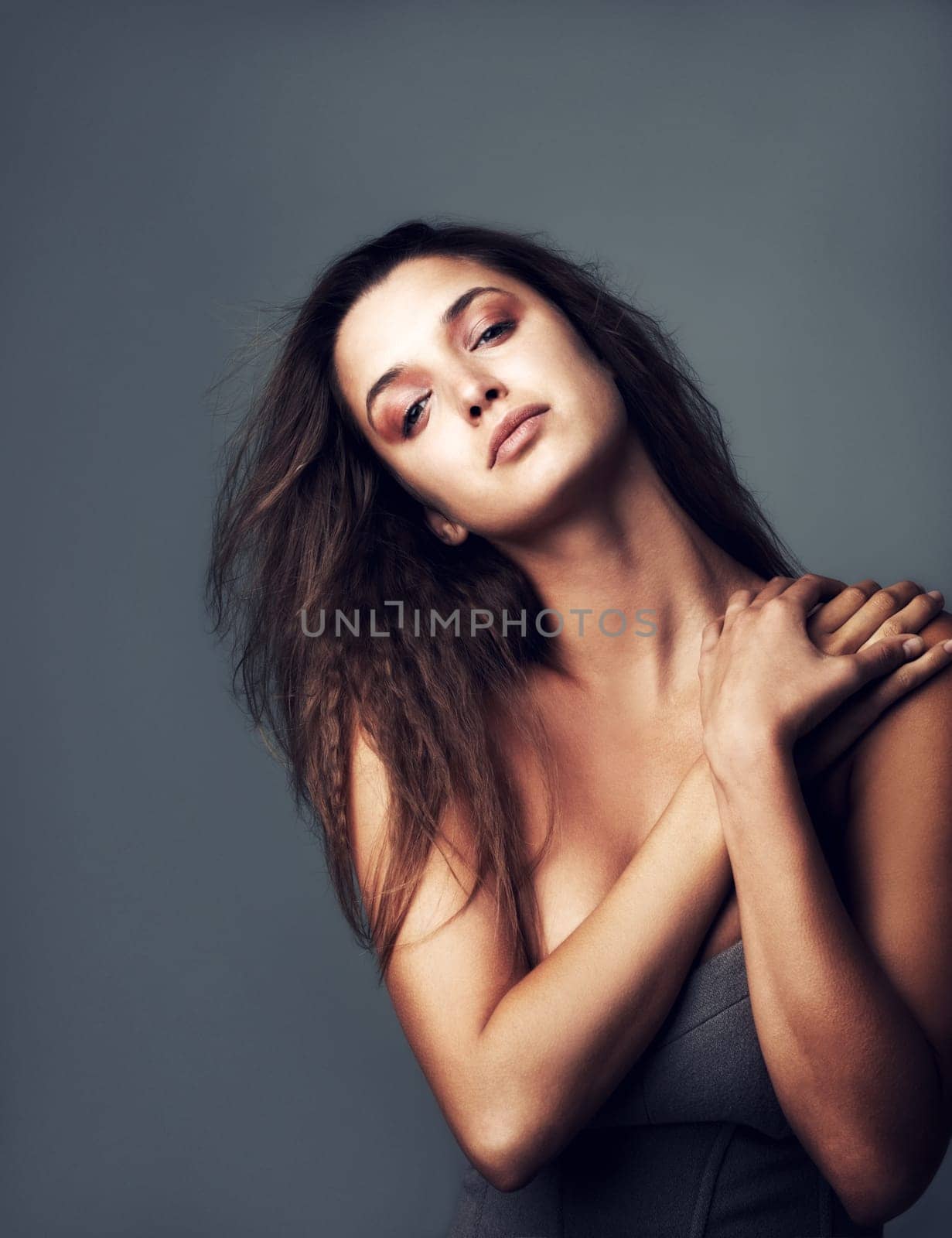 Hair, confident and portrait of woman on gray background for wellness, healthy texture and growth. Attitude, serious and face of person with hairstyle for beauty, haircare and cosmetics in studio.