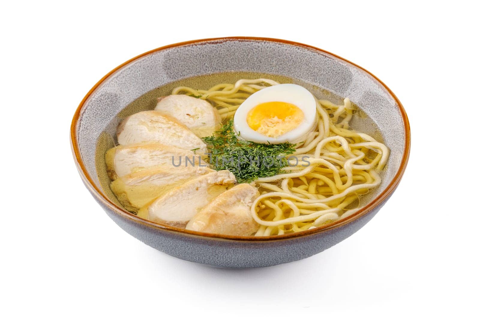 Chicken soup with homemade noodles on a white background studio shot