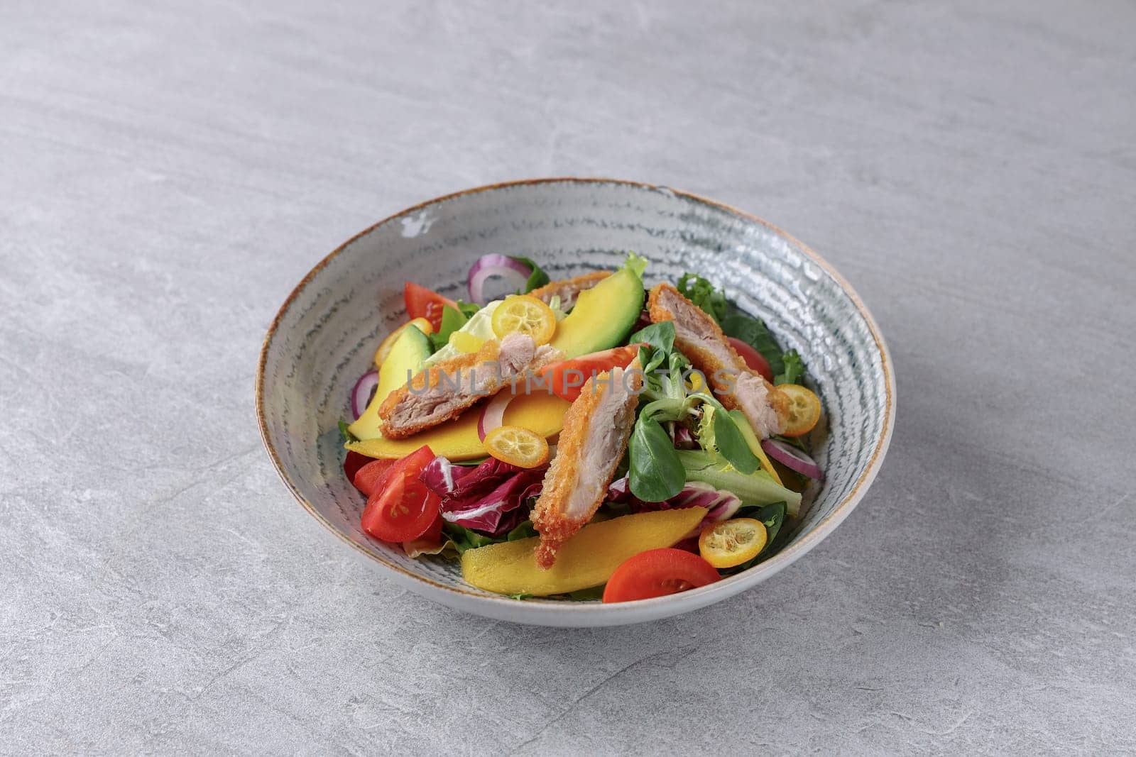 bowl with battered bacon, avocado and kumquat on stone background, studio food photography 1