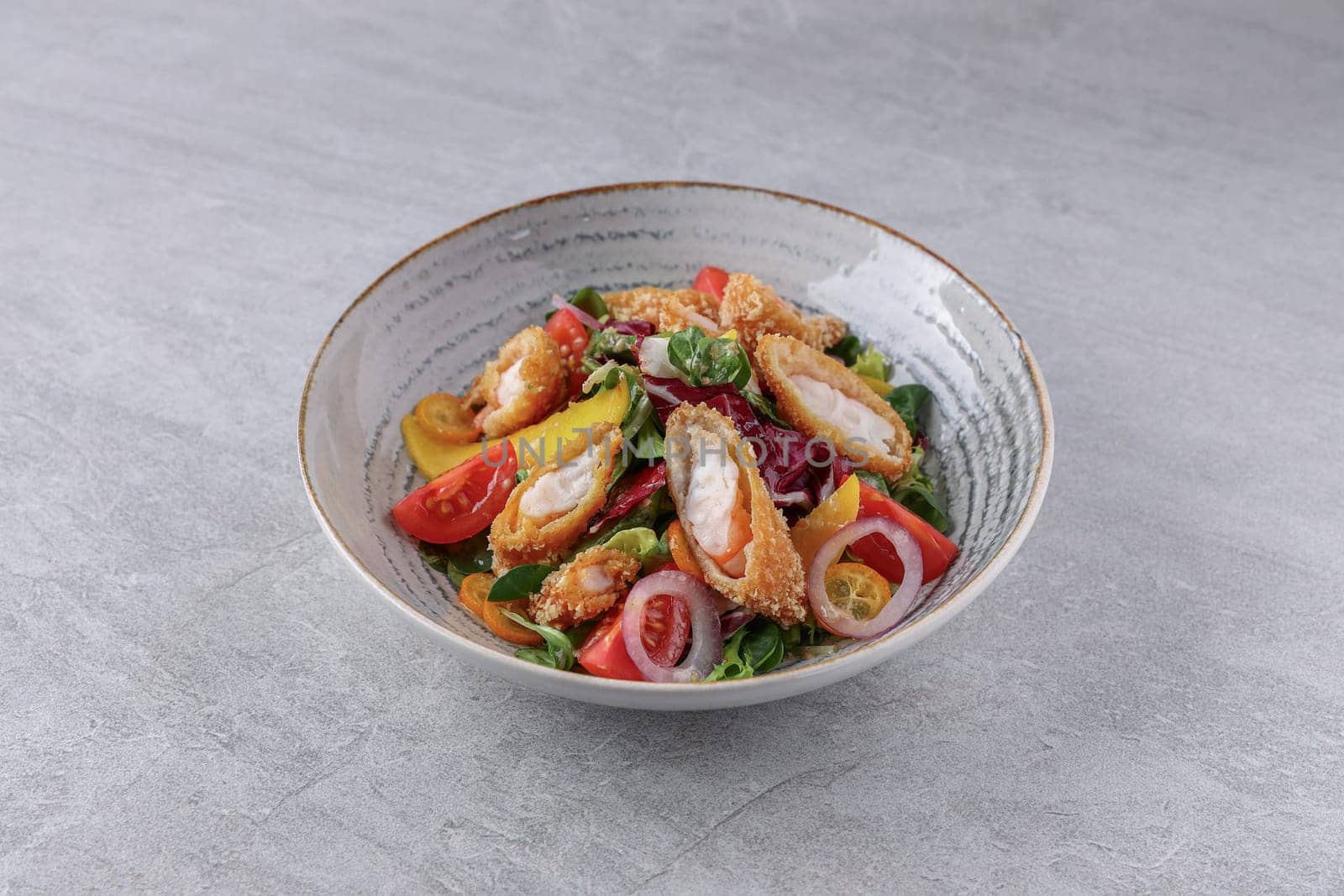 bowl with shrimp in batter, avocado and kumquat on a stone background, studio food photography 2