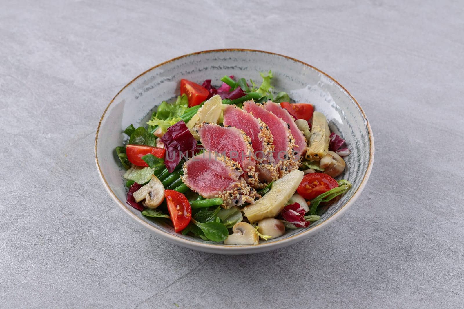 salad with carpaccio, artichoke and asparagus on a stone background, studio food photography 3