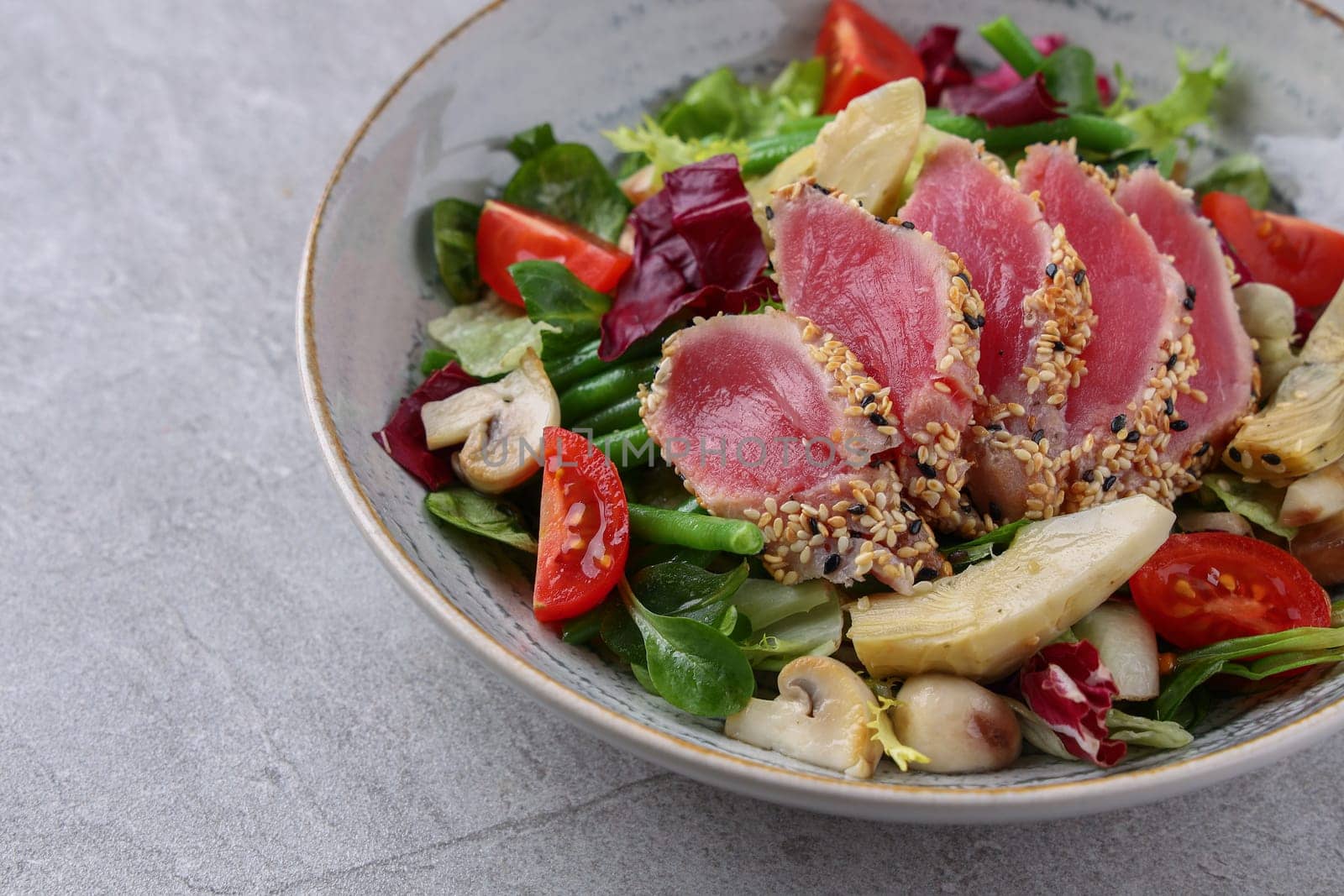 salad with carpaccio, artichoke and asparagus on a stone background, studio food photography 2