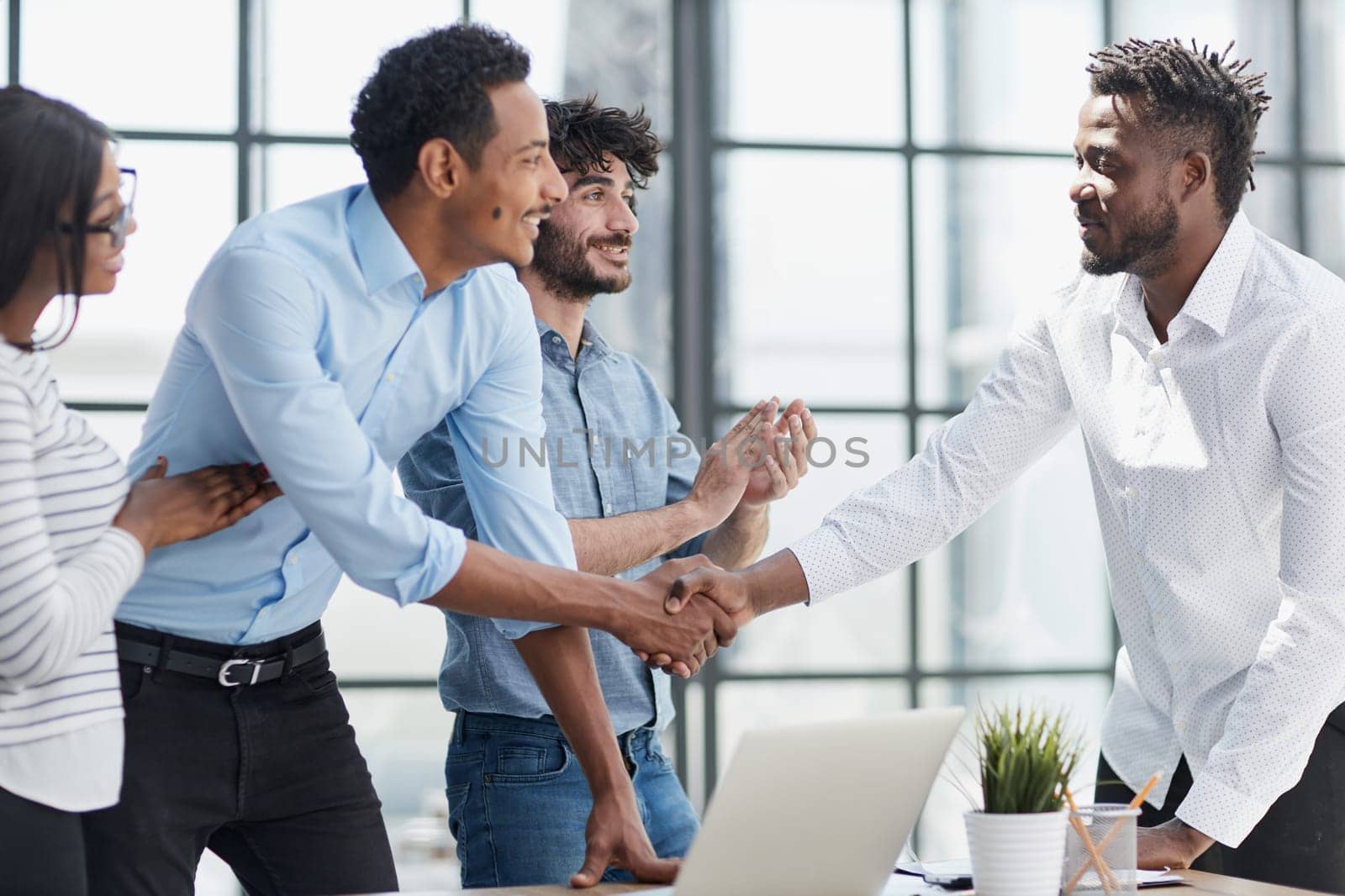 Successful Business Collaboration: Executives Greet with Handshake in Office by Prosto