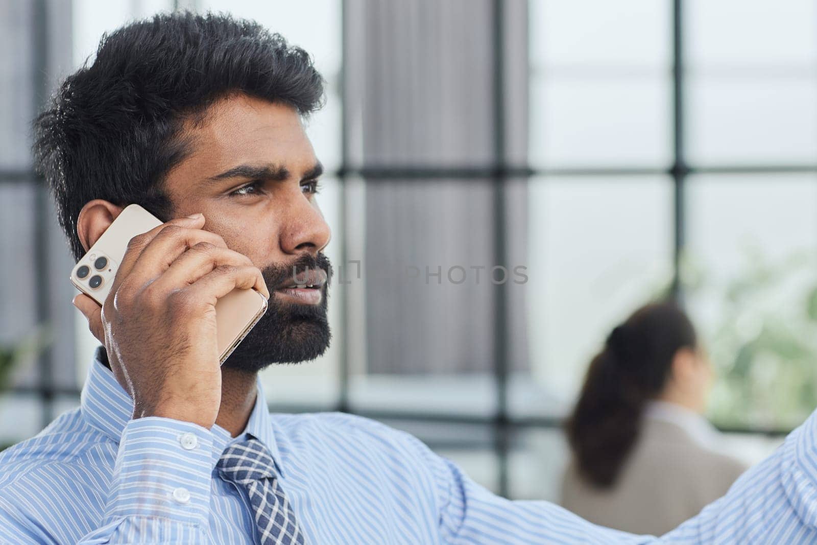 professional businessman executive entrepreneur wearing holding telephone making corporate call on cellphone. by Prosto