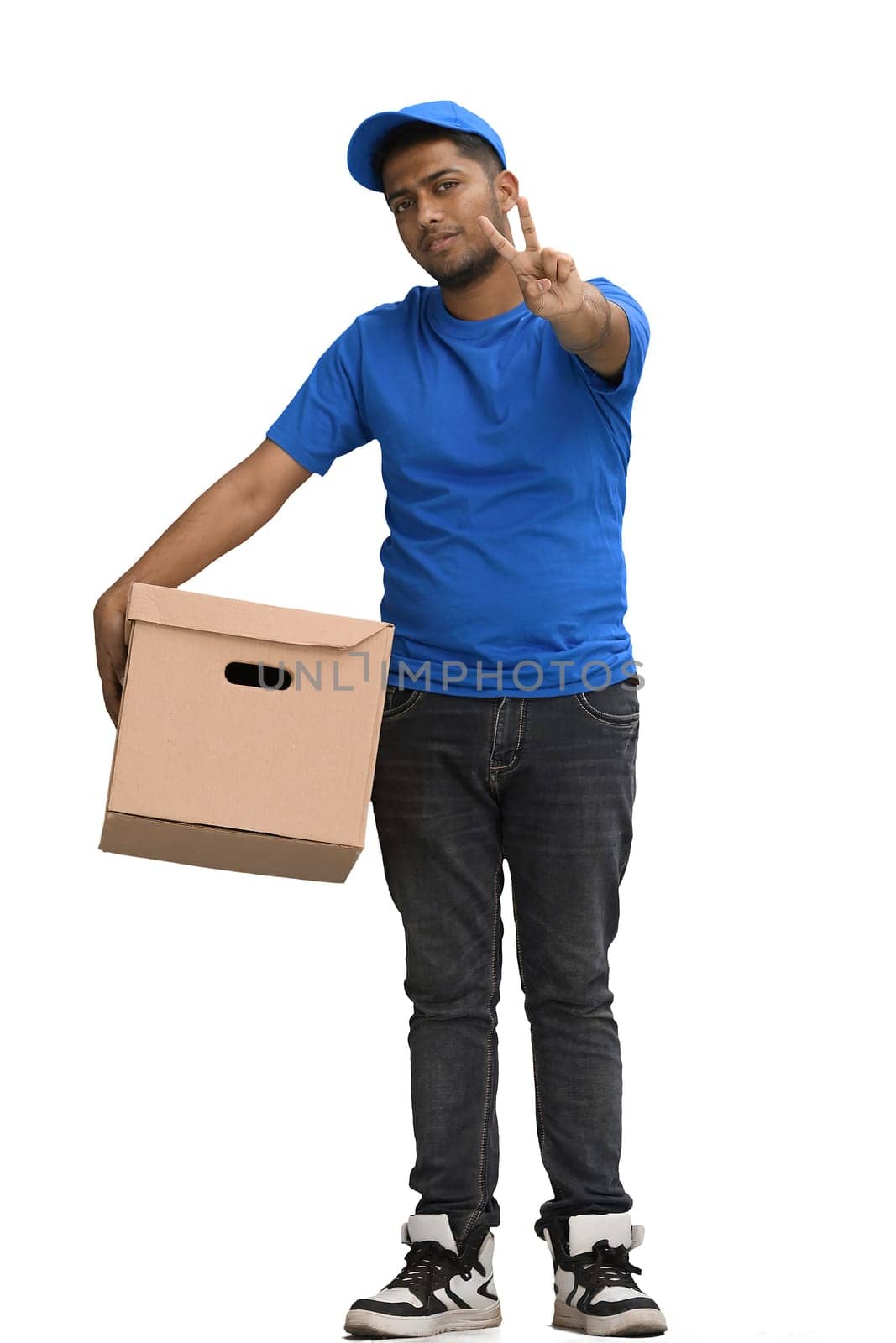 A man on a white background with box show a victory sign.