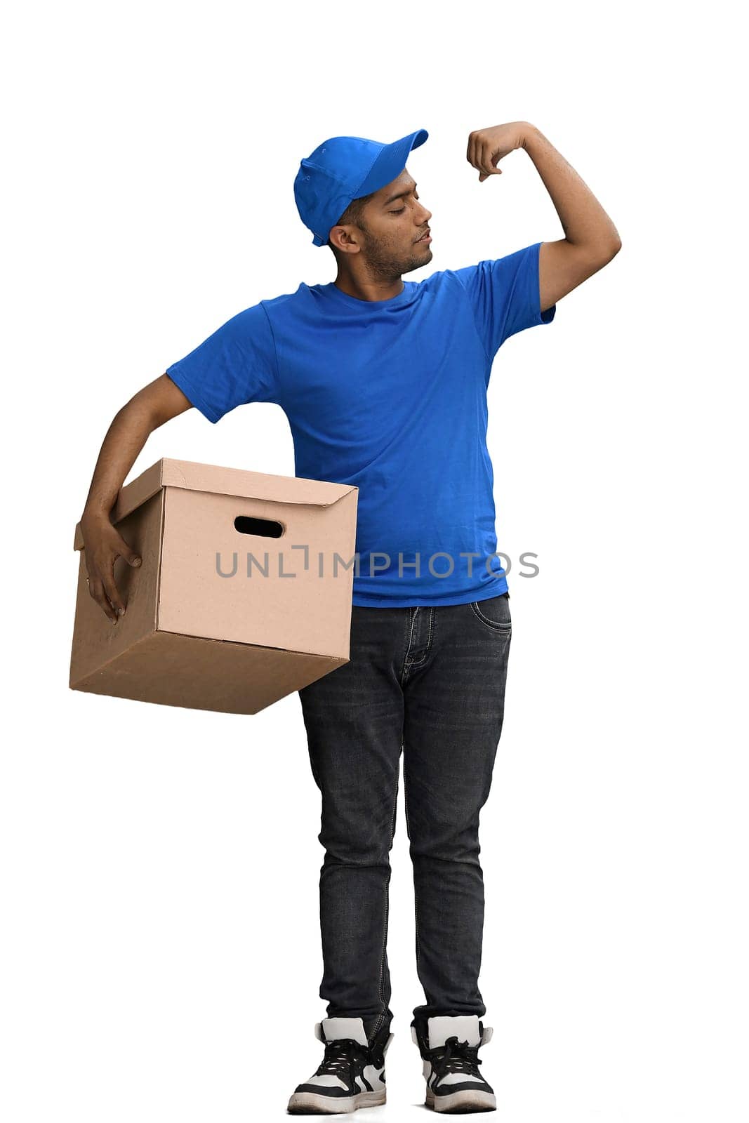 A man on a white background with box demonstrates strength with his hand.
