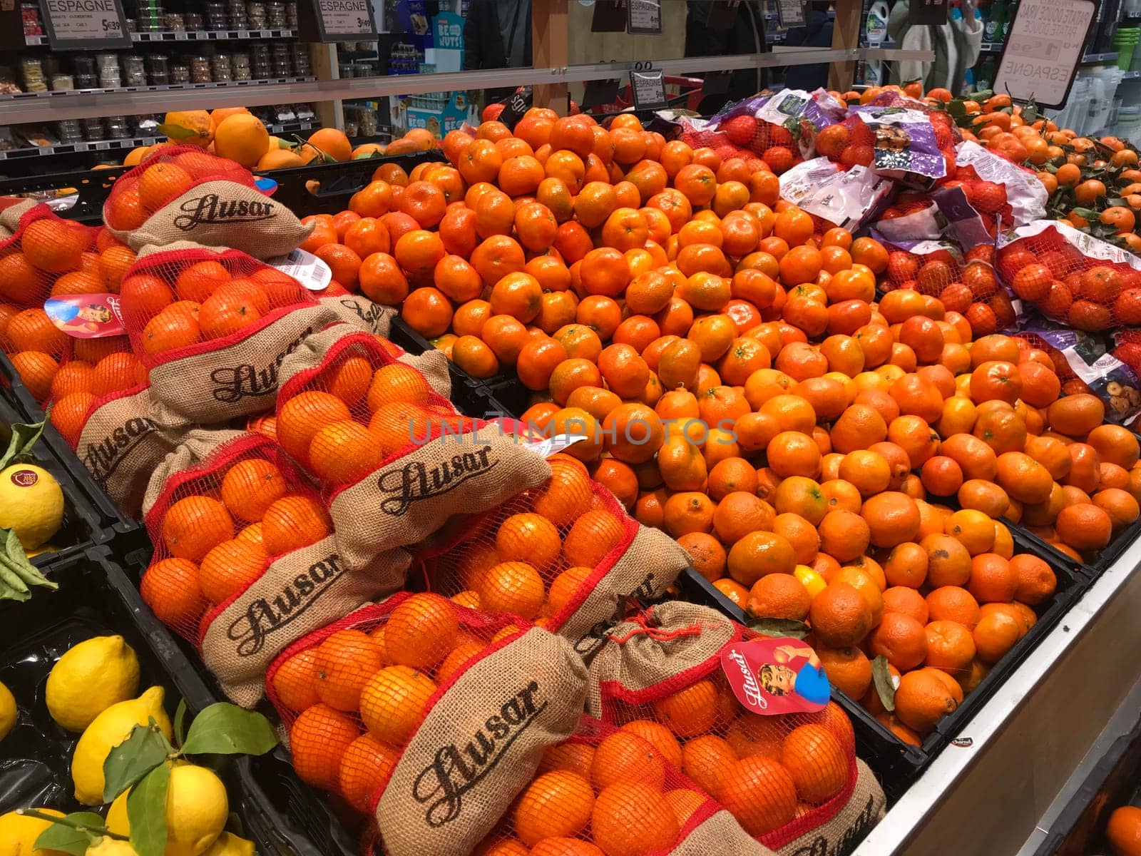 Mandarin orange fruits for sale at the supermarket with one fruit peeled, Mandarin orange full of vitamin c by FreeProd