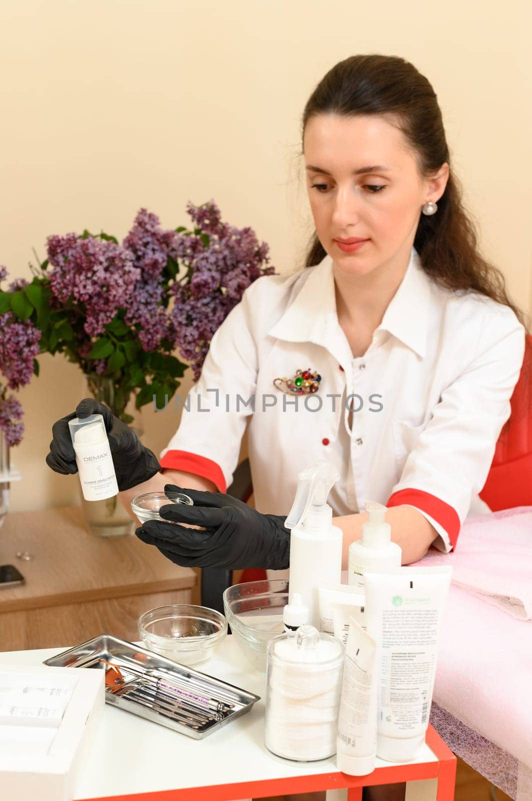 Ivano-Frankivsk, Ukraine, May 17, 2023: a cosmetologist holds a carbotherapy agent in his hands. by Niko_Cingaryuk
