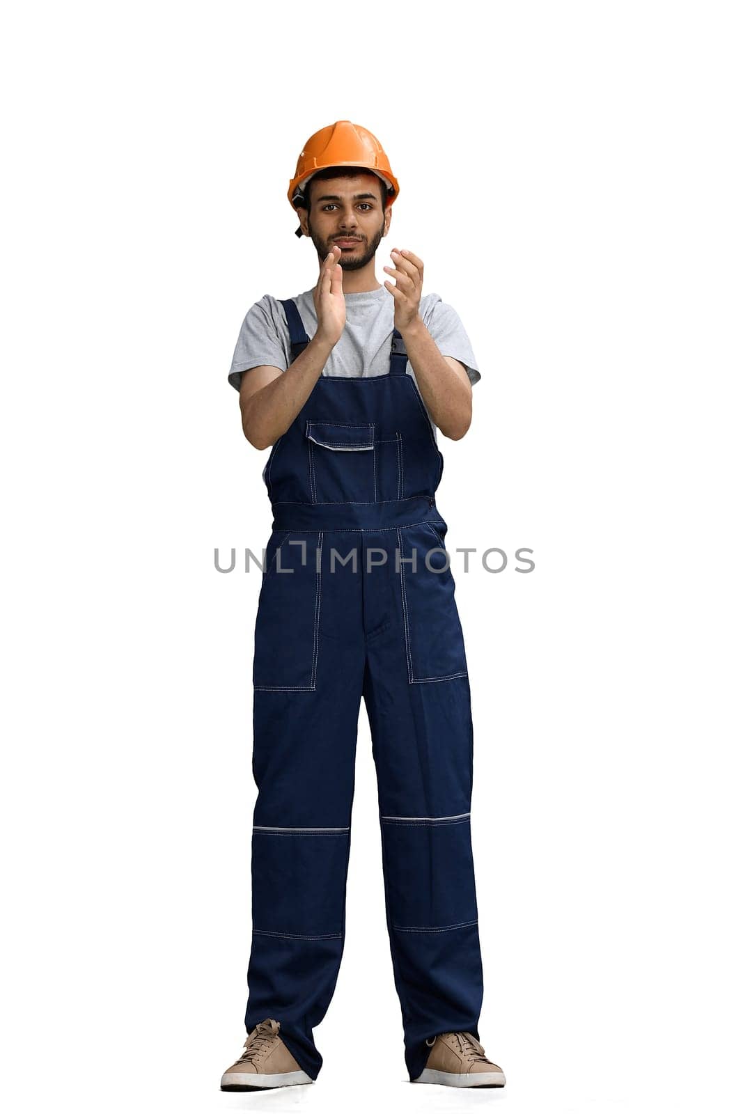 A builder male on a white background claps in hand.