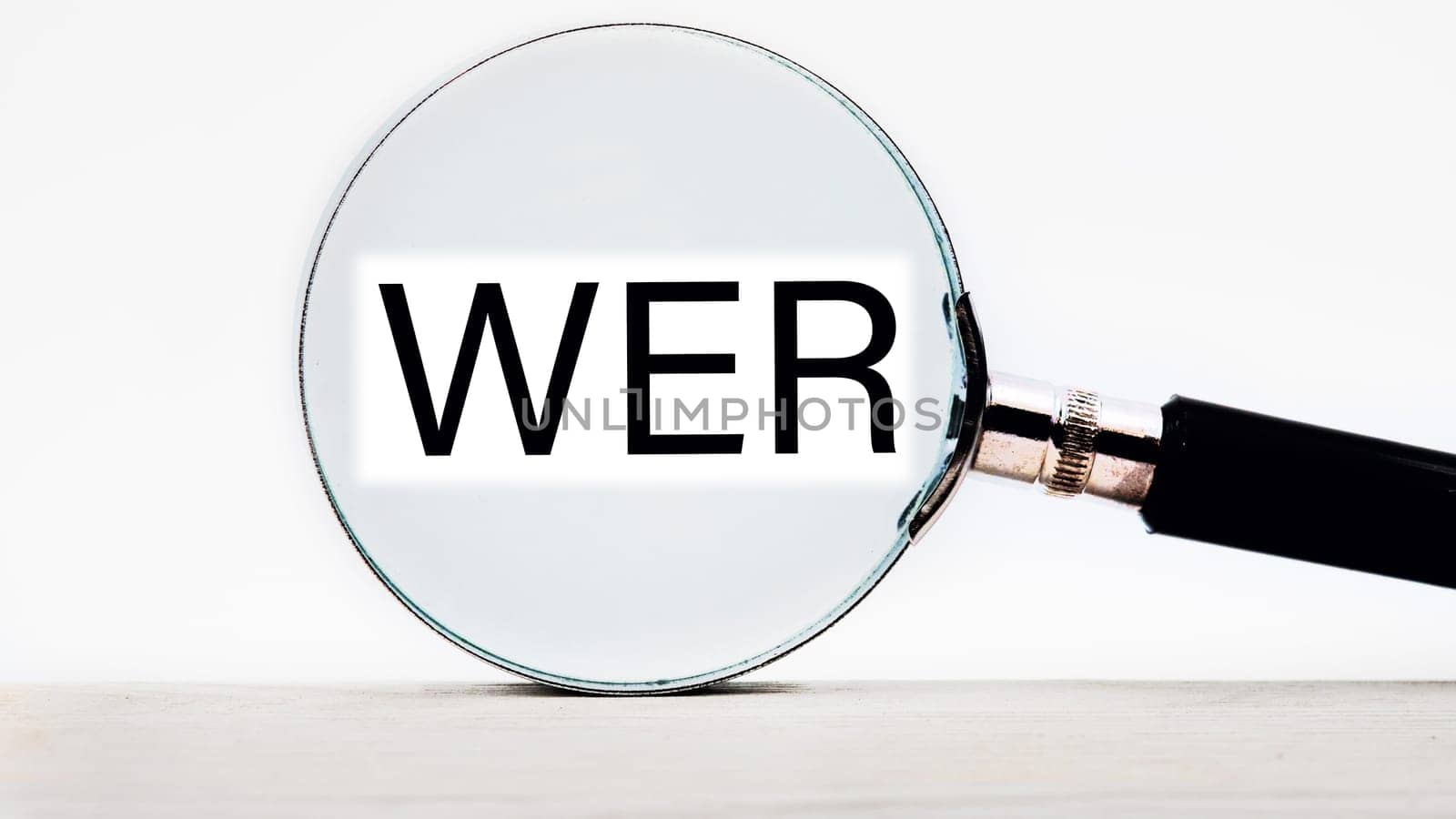 Who, German word for Who, (German: Wer) lettering on through a magnifying glass on a light background